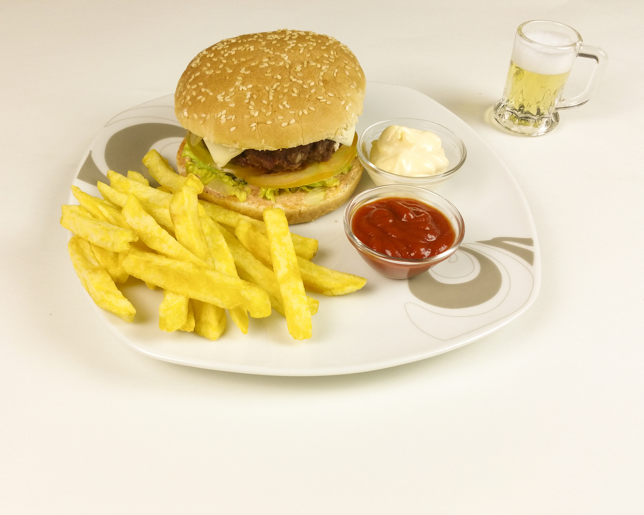 burger and chips on wooden background
