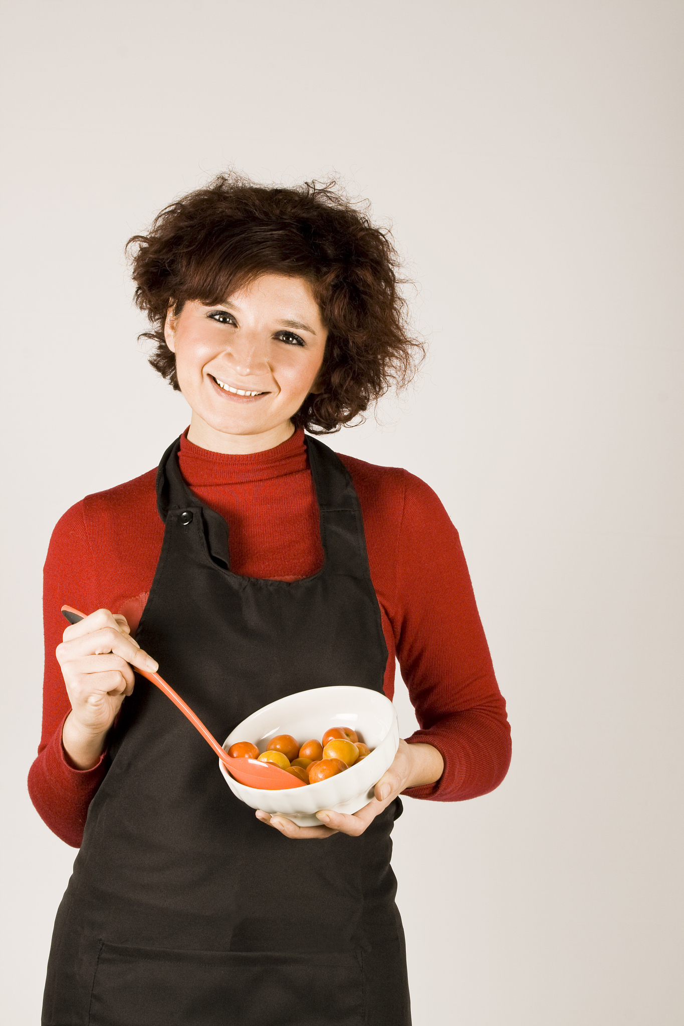 woman mixing tomatoes
