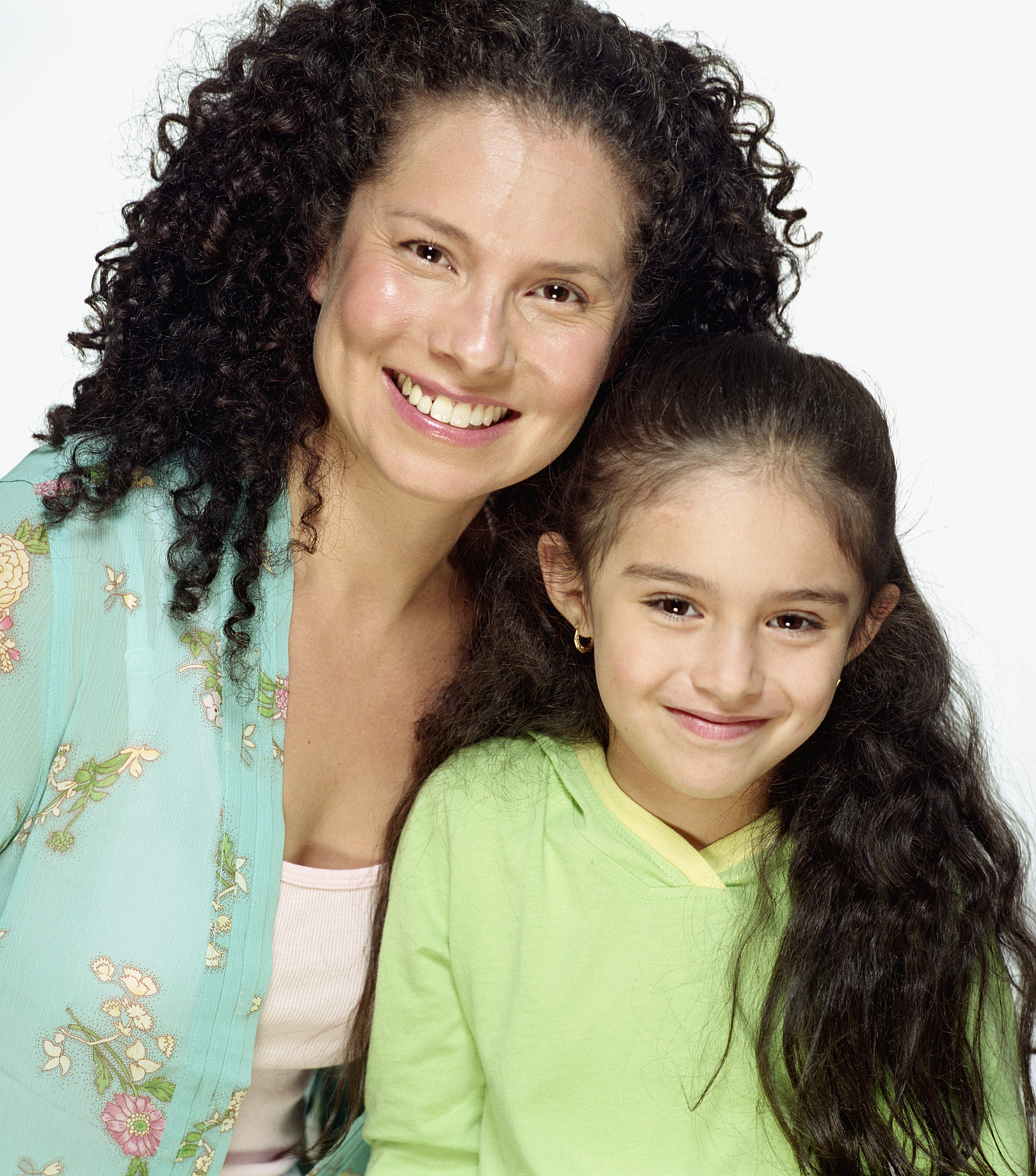mother and daughter (5-7) smiling, portrait