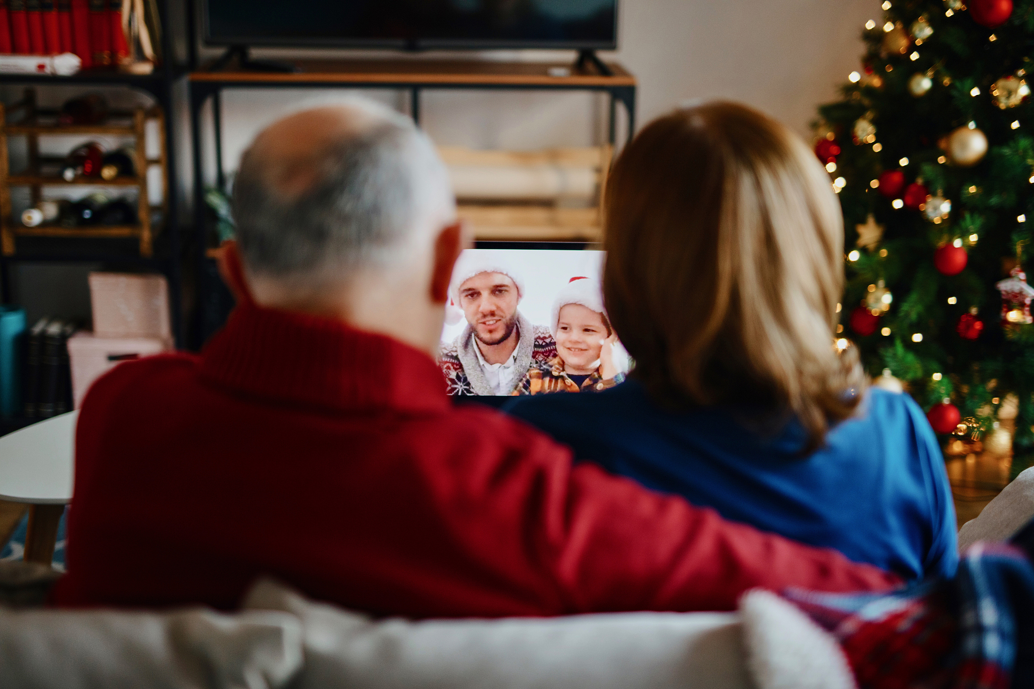 happy grandparents having video call with family on christmas