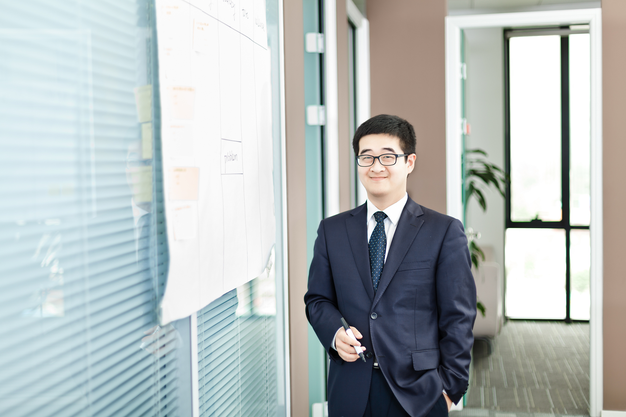 young man writing on whiteboard