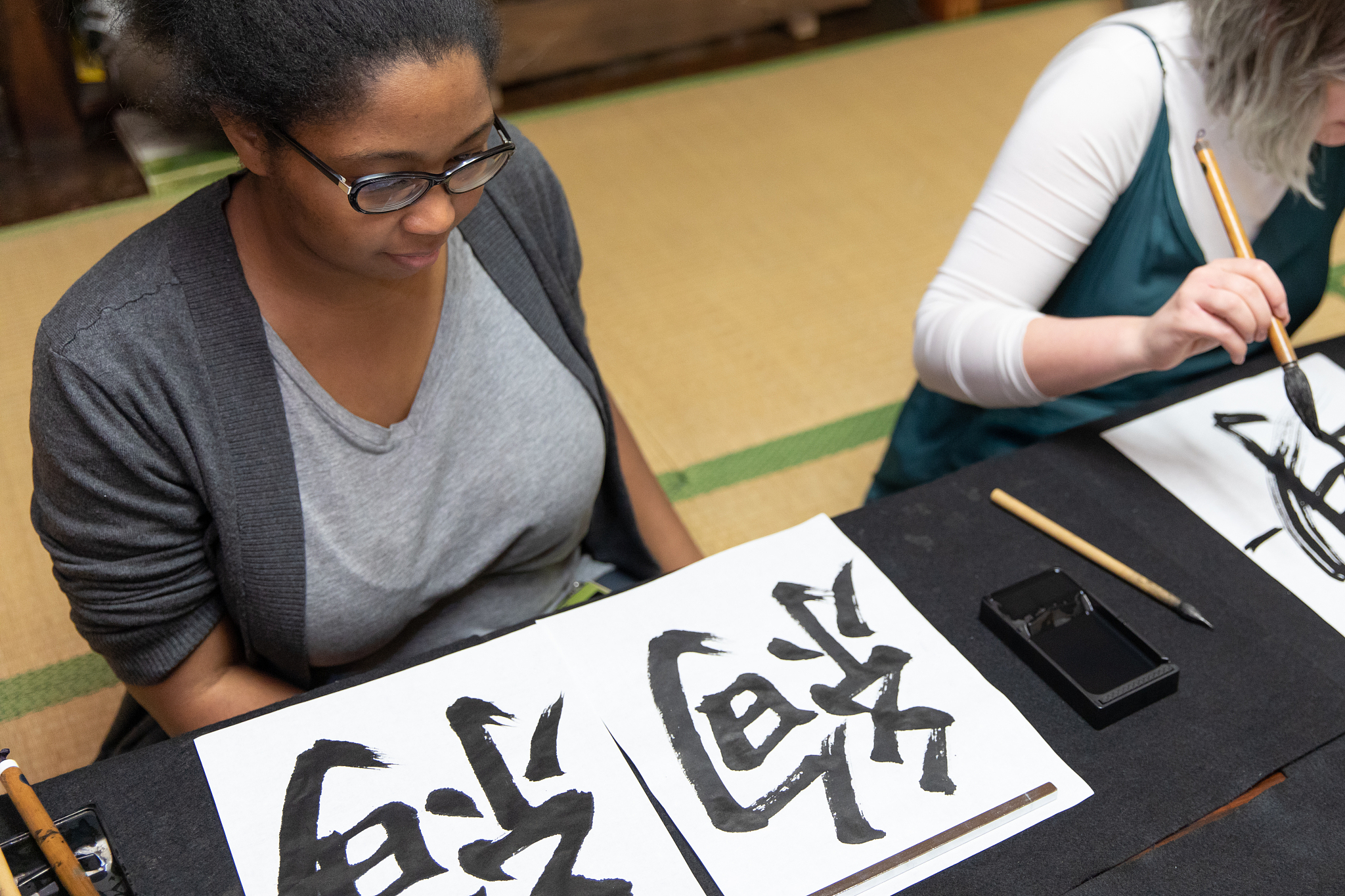 foreign people learning japanese calligraphy