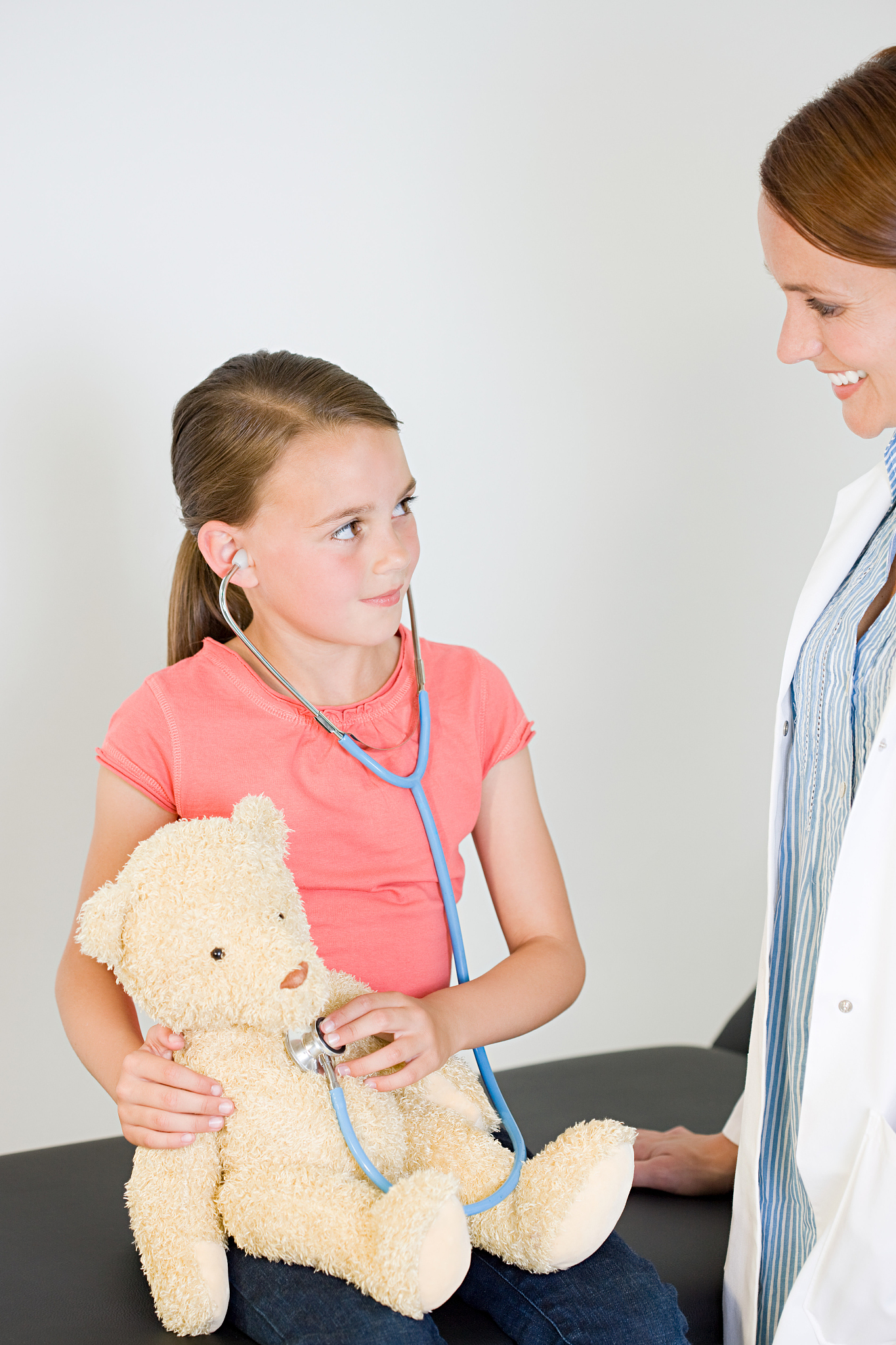 doctor and girl with teddy bear