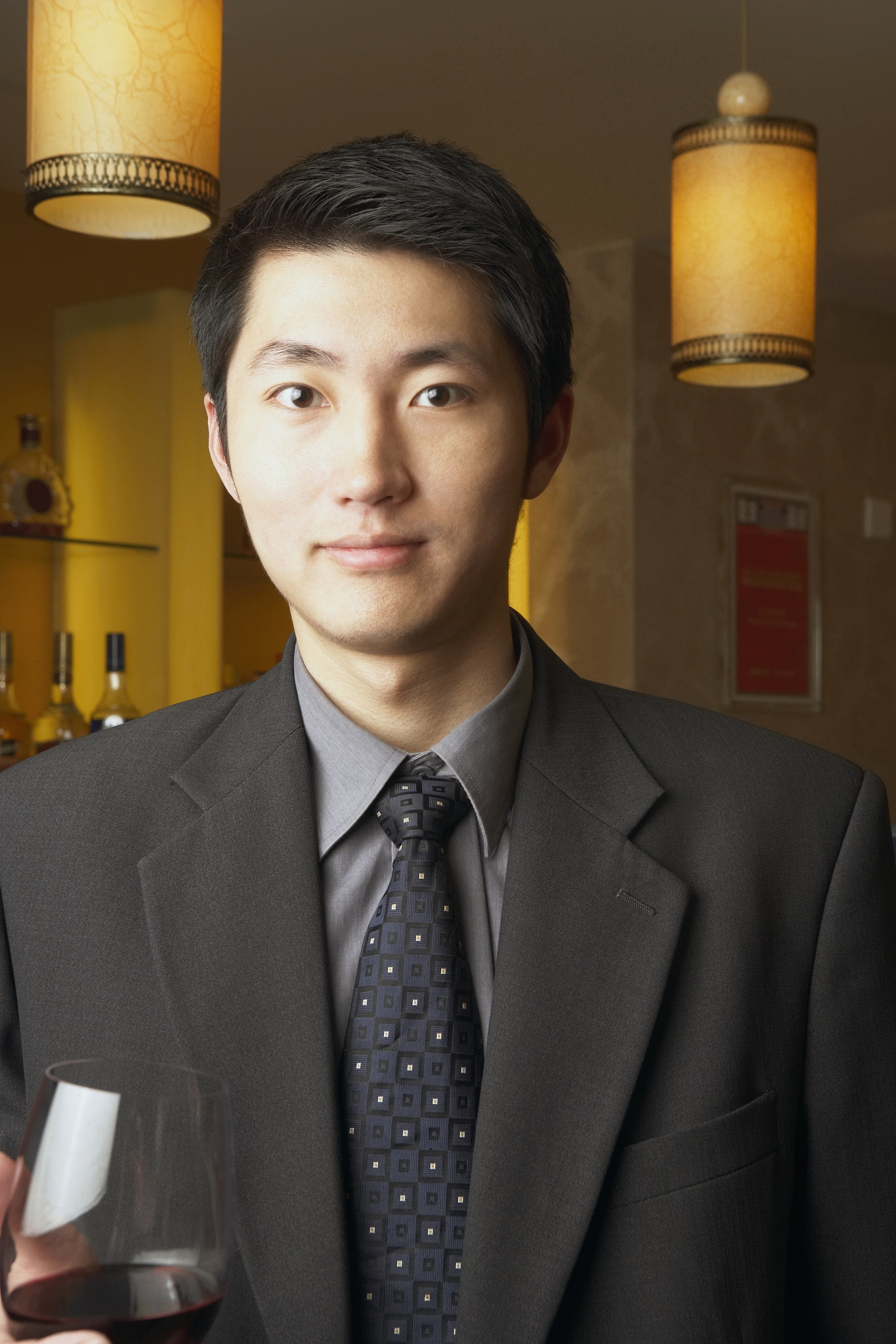 portrait of a businessman holding a red wineglass