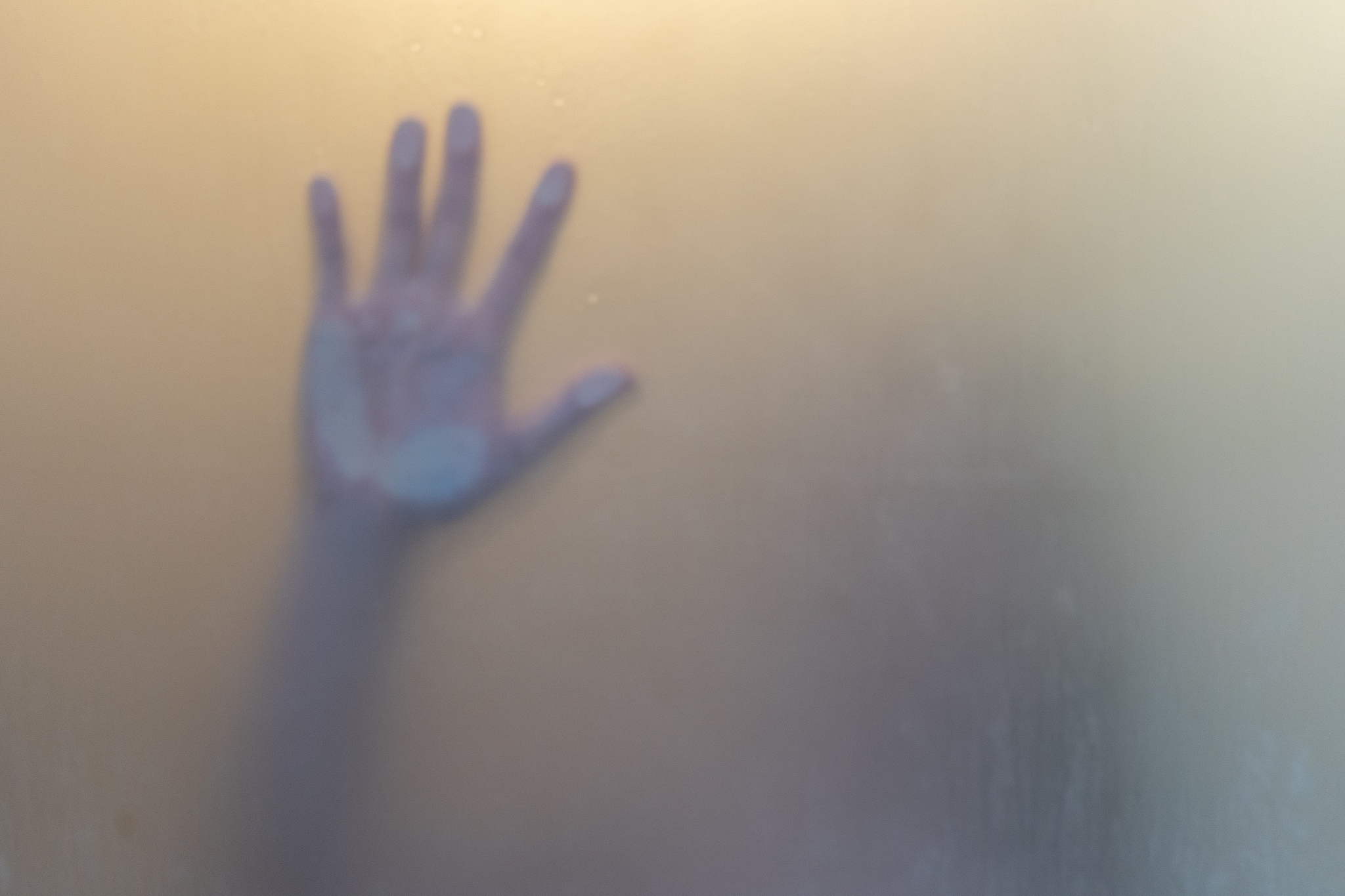 close-up of hand touching window