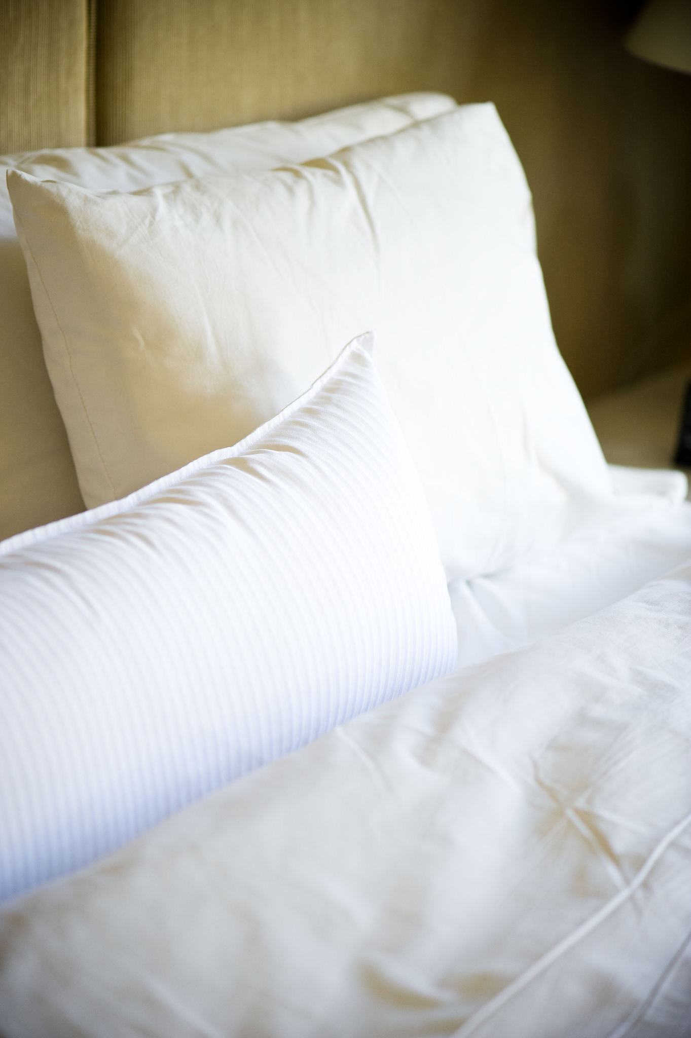 soft comfortable pillows and sheets on bed in bedroom