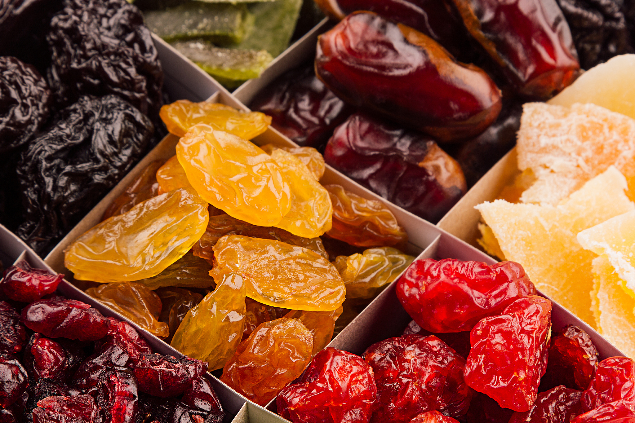 assortment of dried fruits closeup background in square cells.