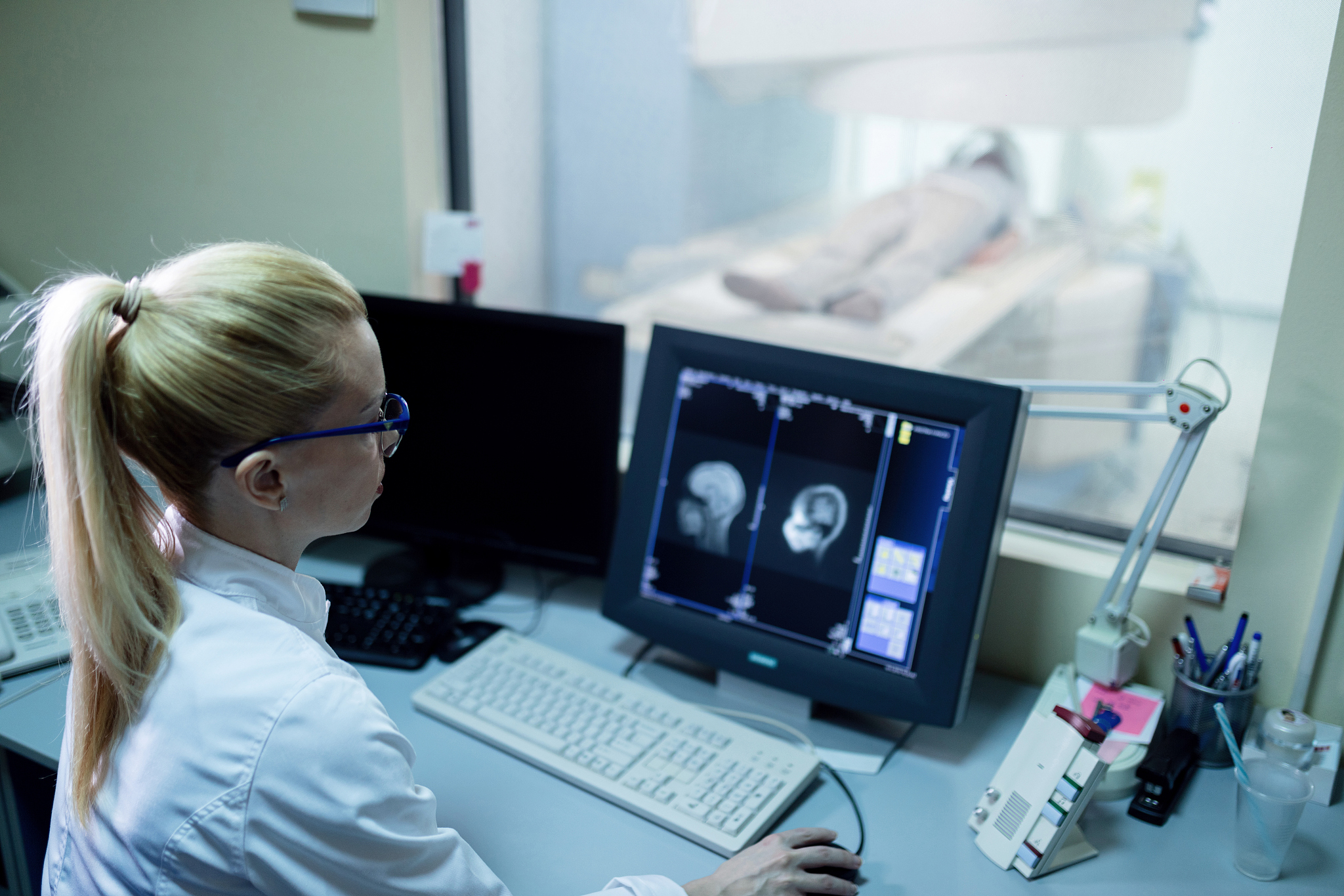 female radiologist examining mri scan results of a patient in co