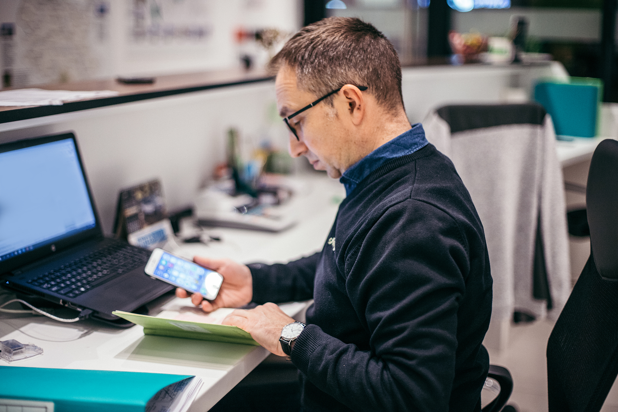 man is text messaging at the office