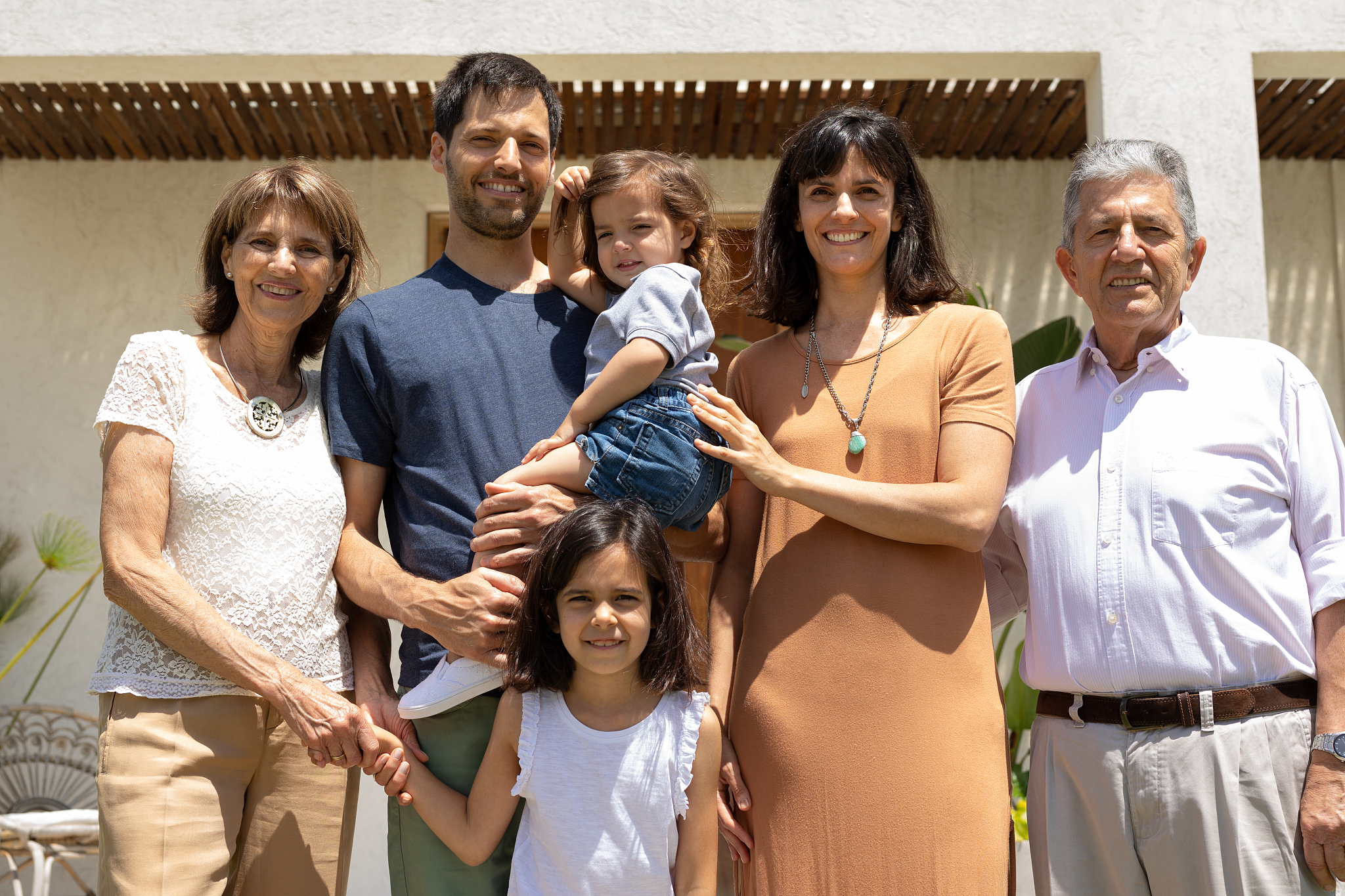 multigeneration family portrait in front of the house