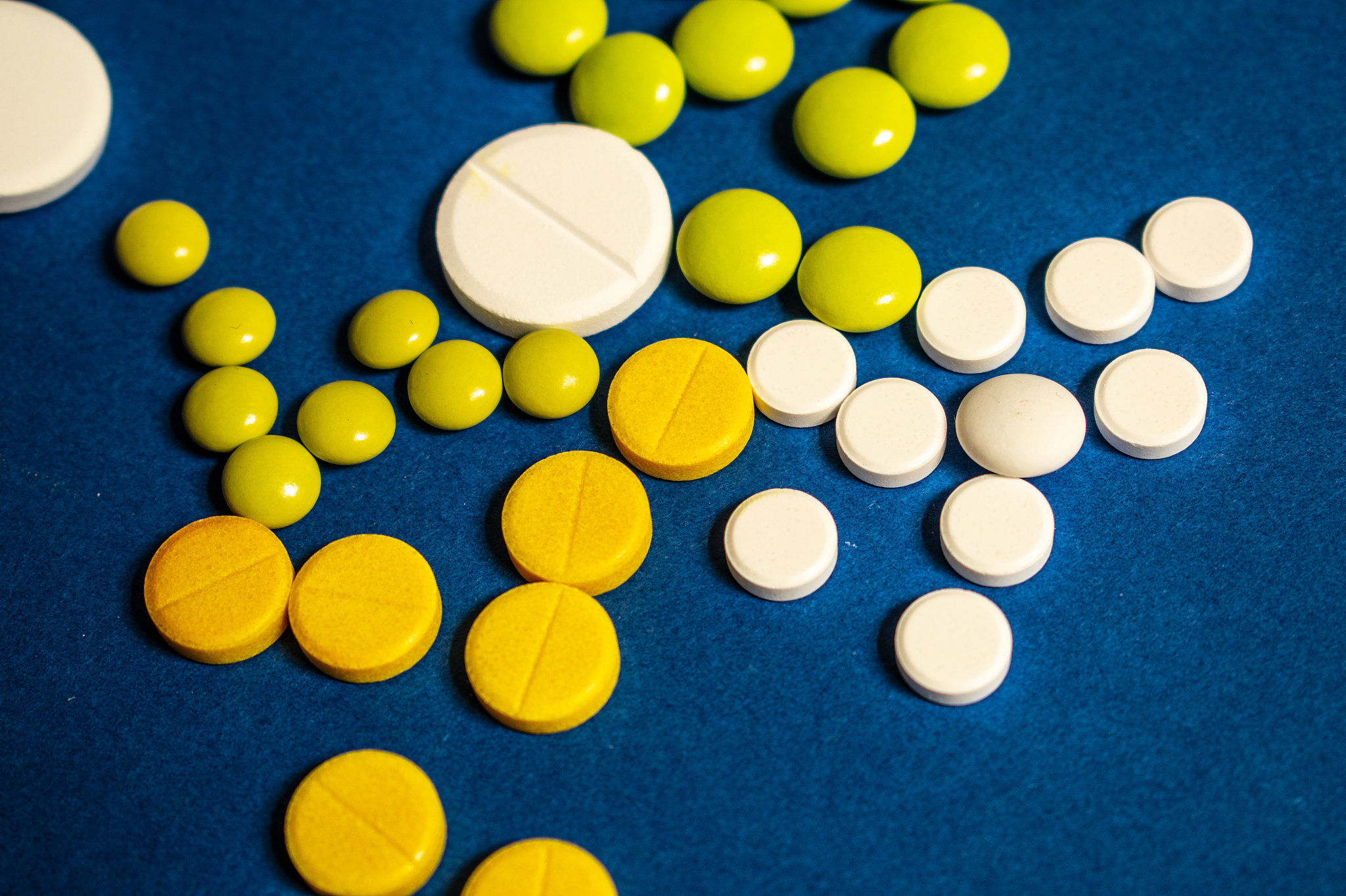 colored pills on a blue background