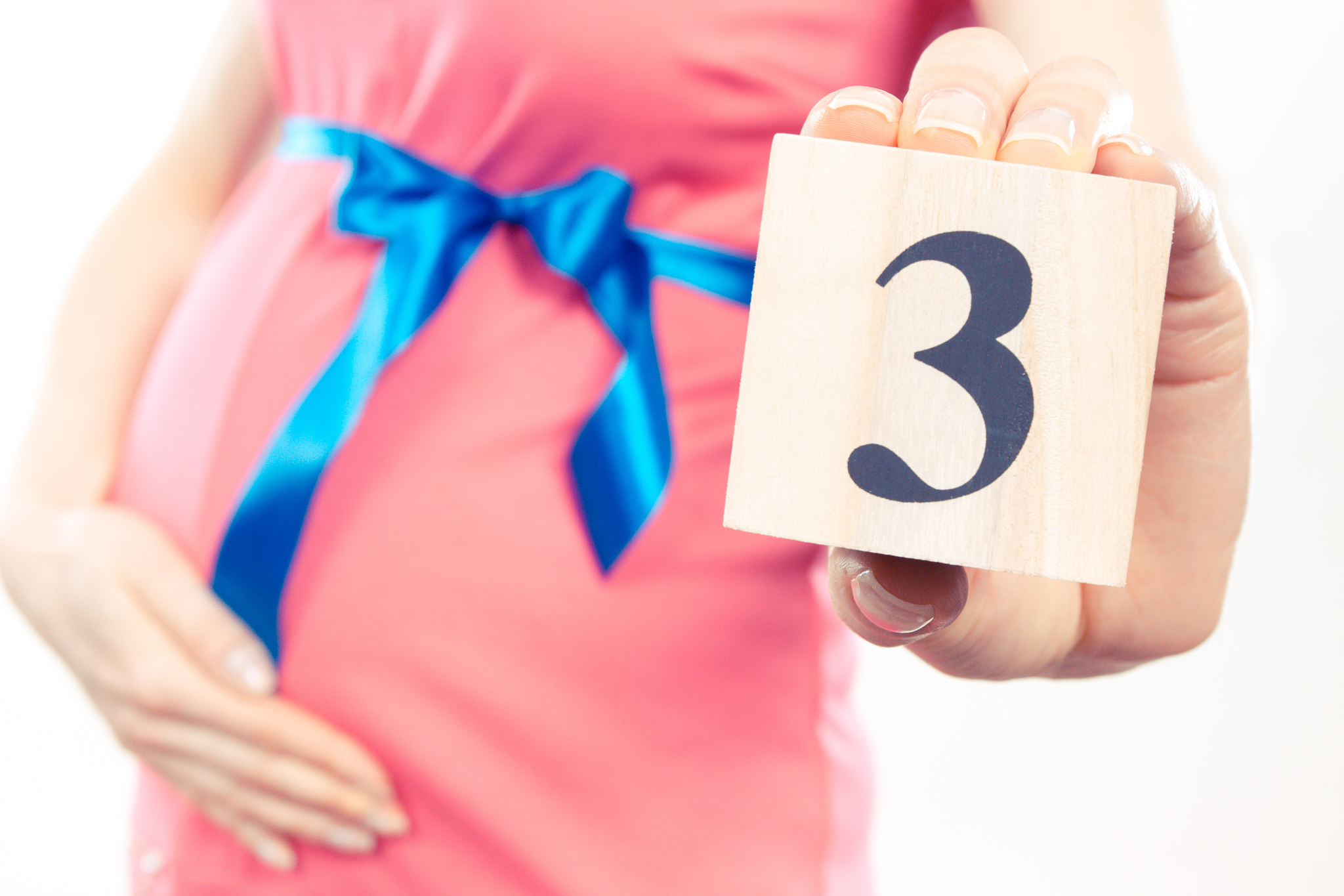 vintage photo, hand of woman showing number of third month of pr