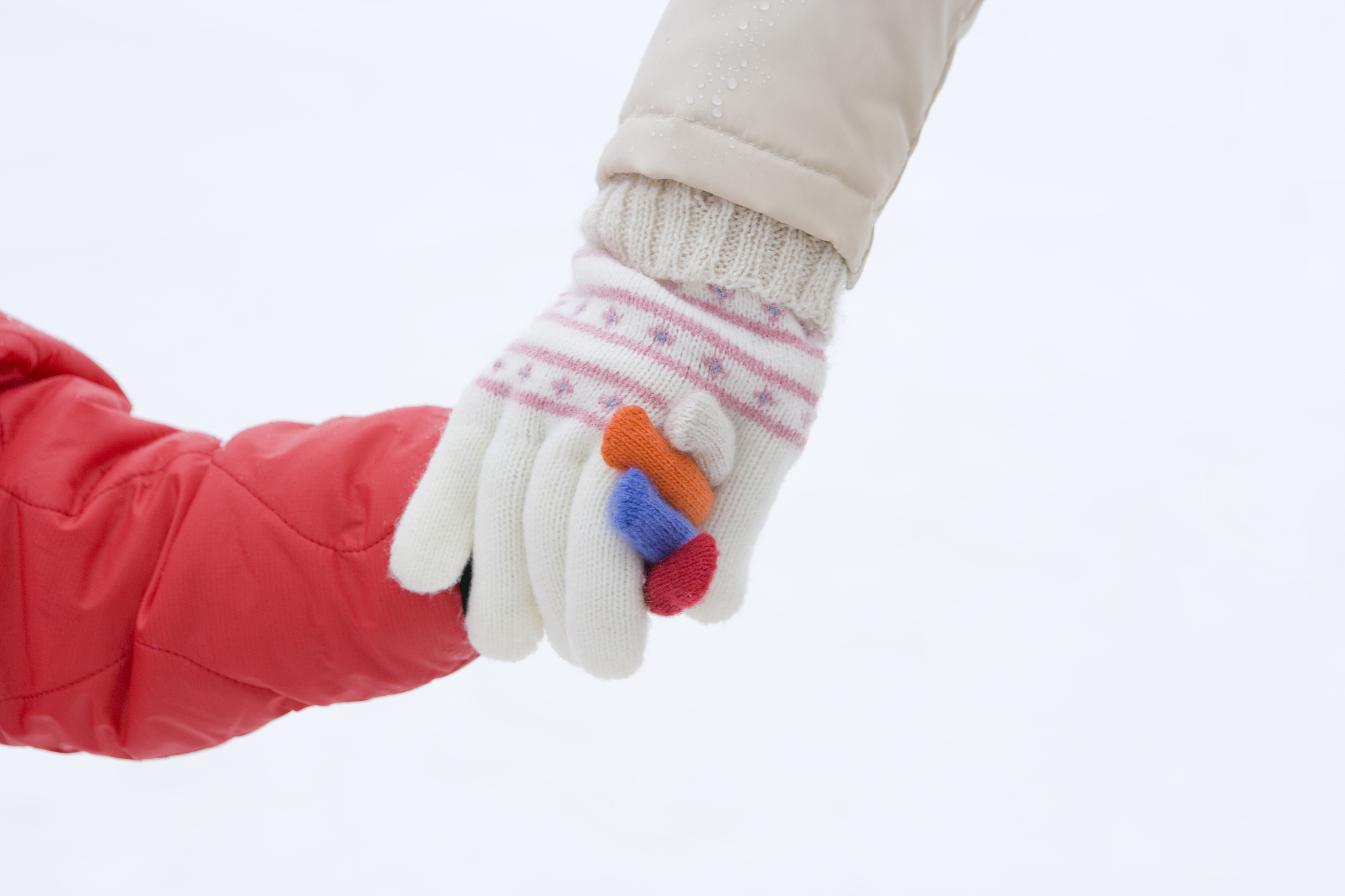 girl walking with her mother, hand in hand, close up, white back
