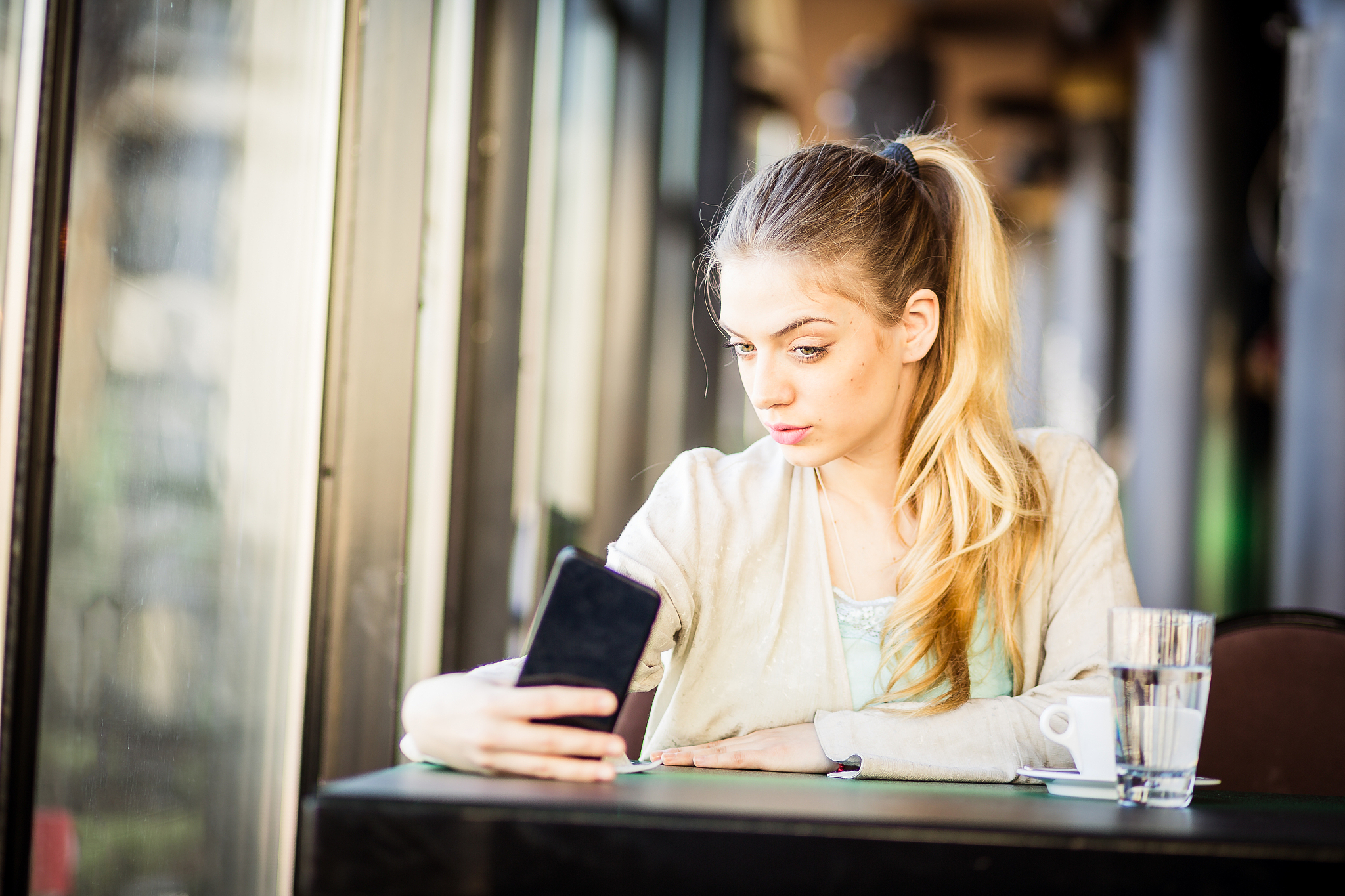 woman drinking coffee texting, taking selfie. belgrade, serbia, 