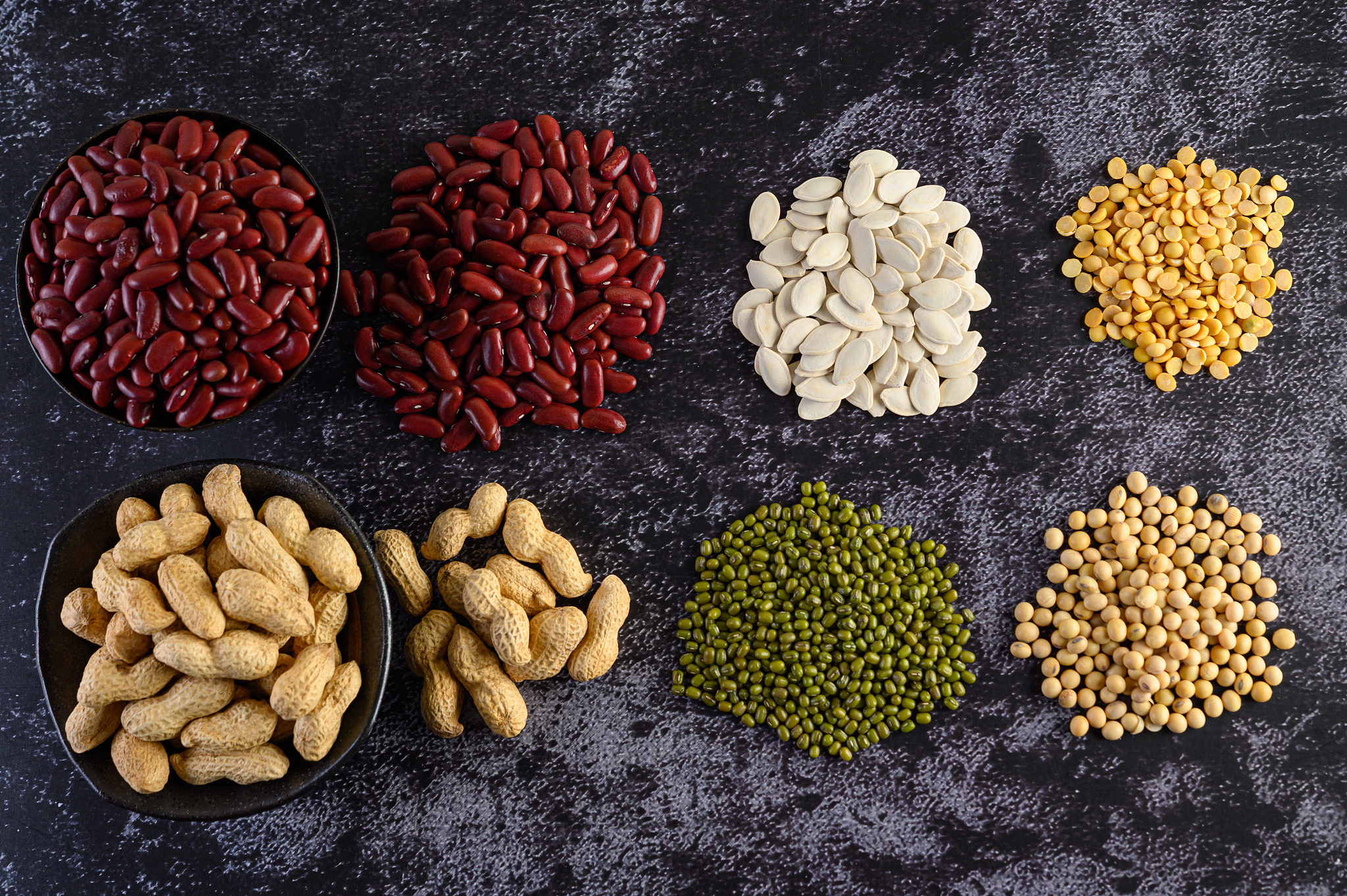 legumes, and beans assortment on the black cement floor. top vie