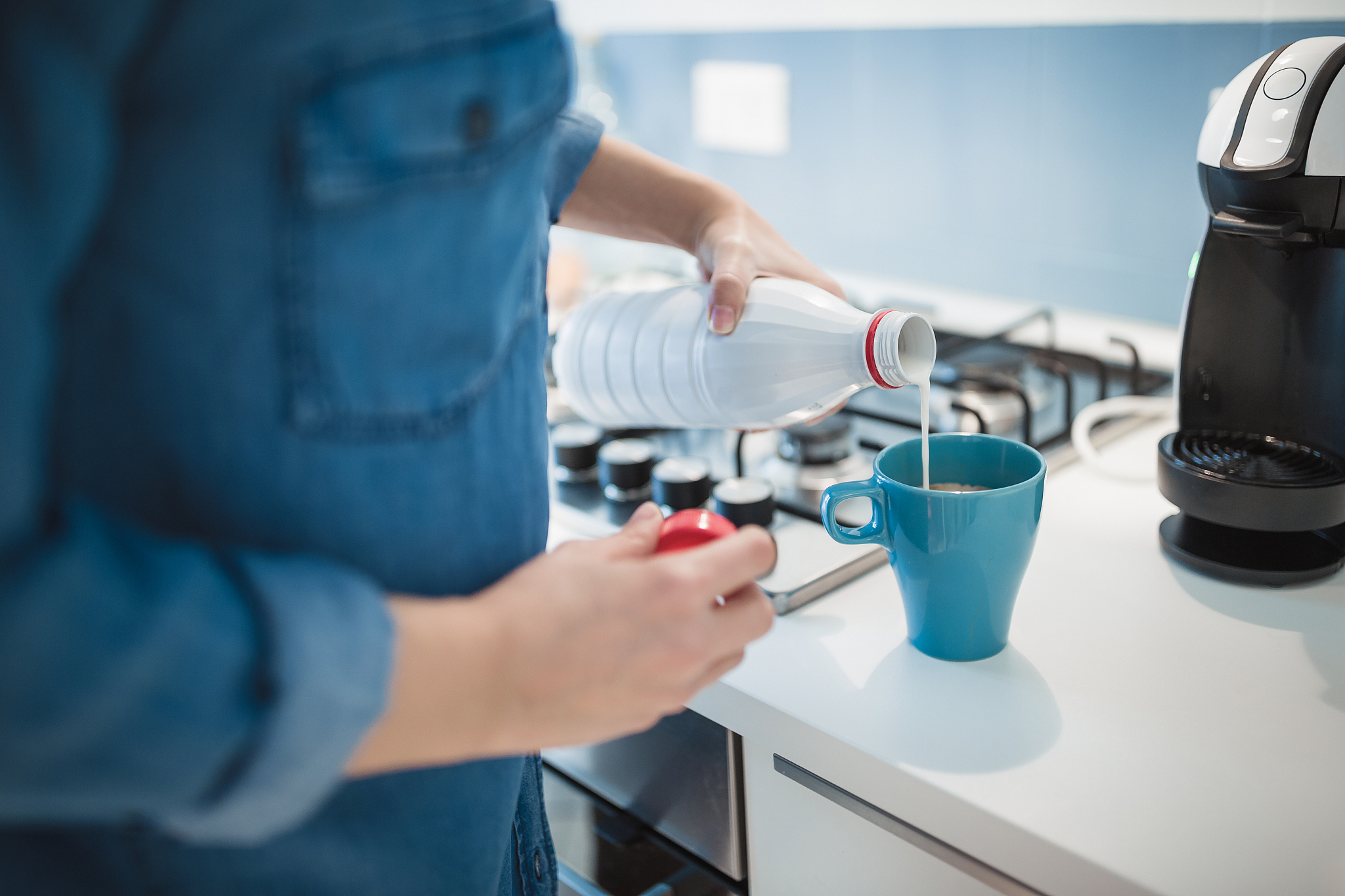 young woman is making morning coffee in her kitchen.