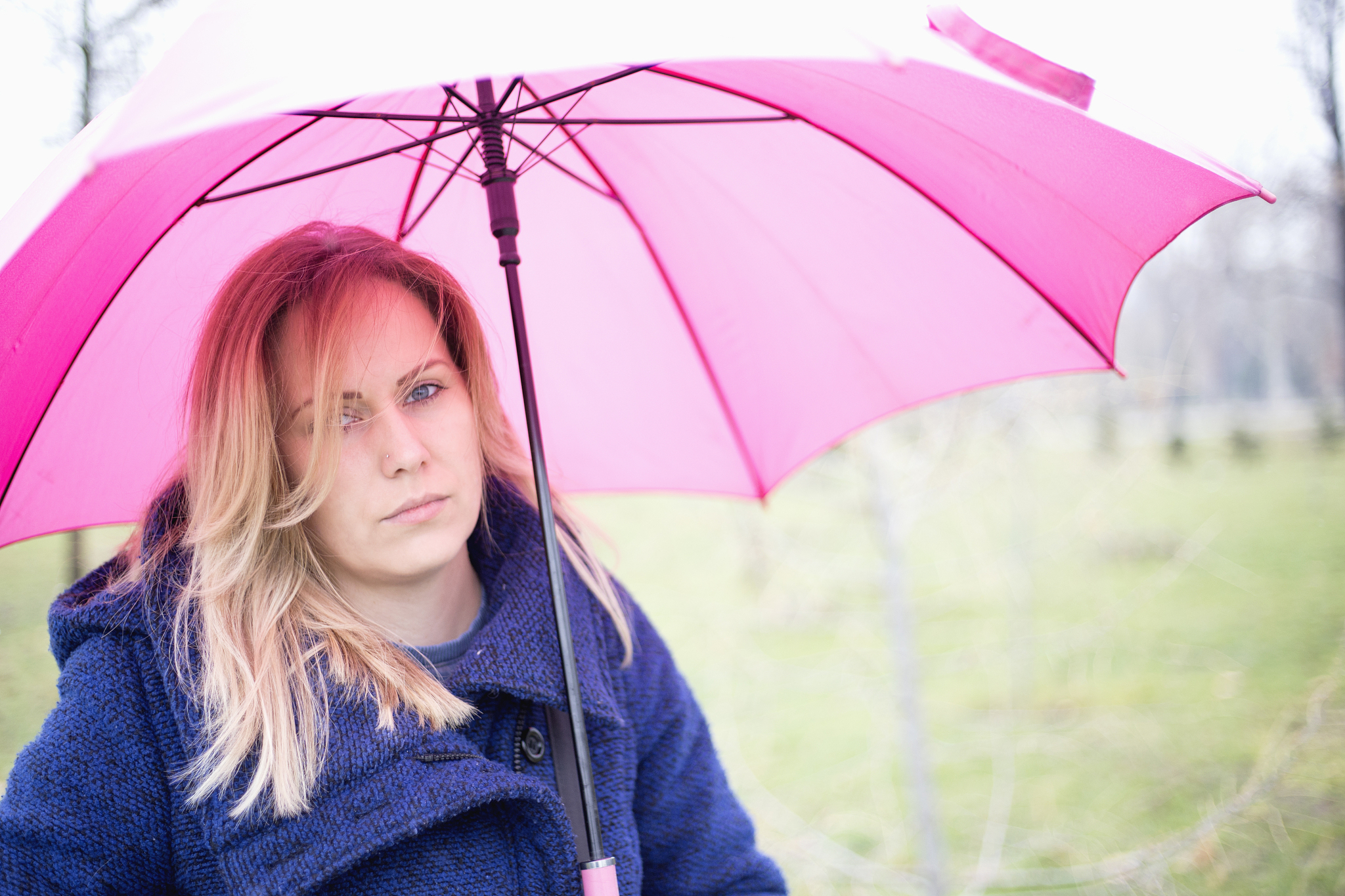 Adorable Girl Explores Vast Grasslands with Umbrella in the Rain