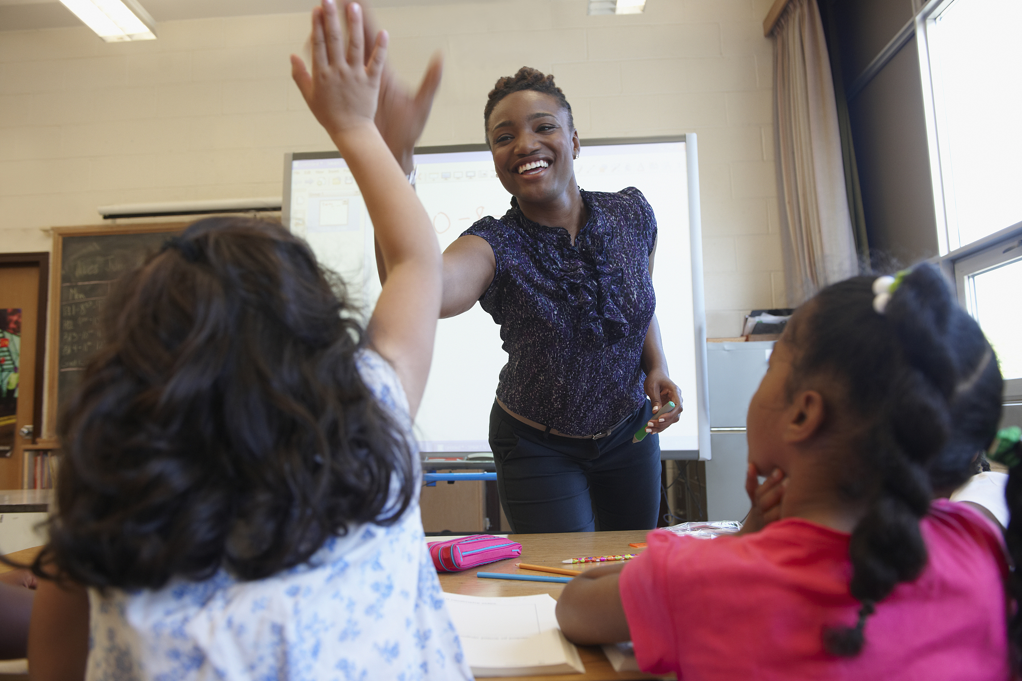 teacher 'high fiving' student