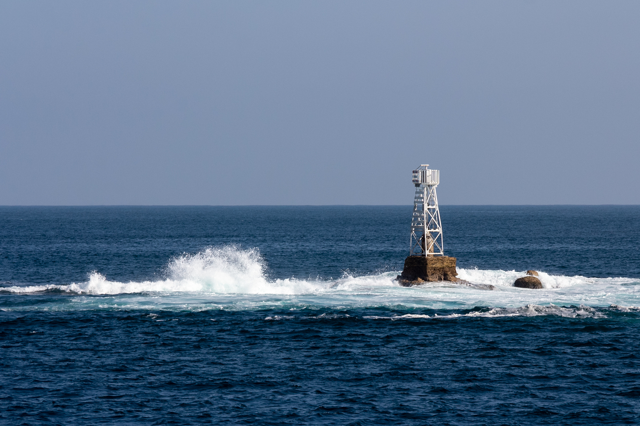 great ocean, waves bursting on the rocks, safety buoy, lighthous