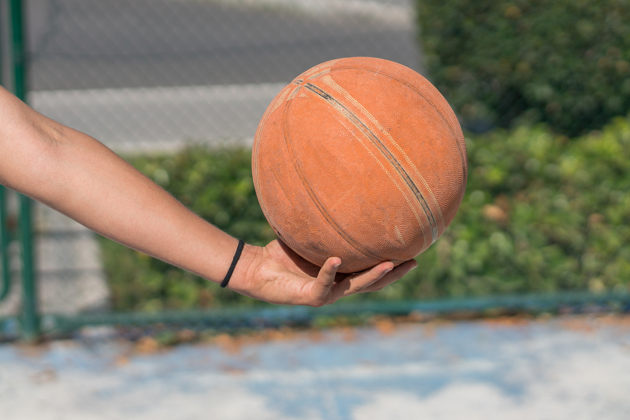 young men holding basketball
