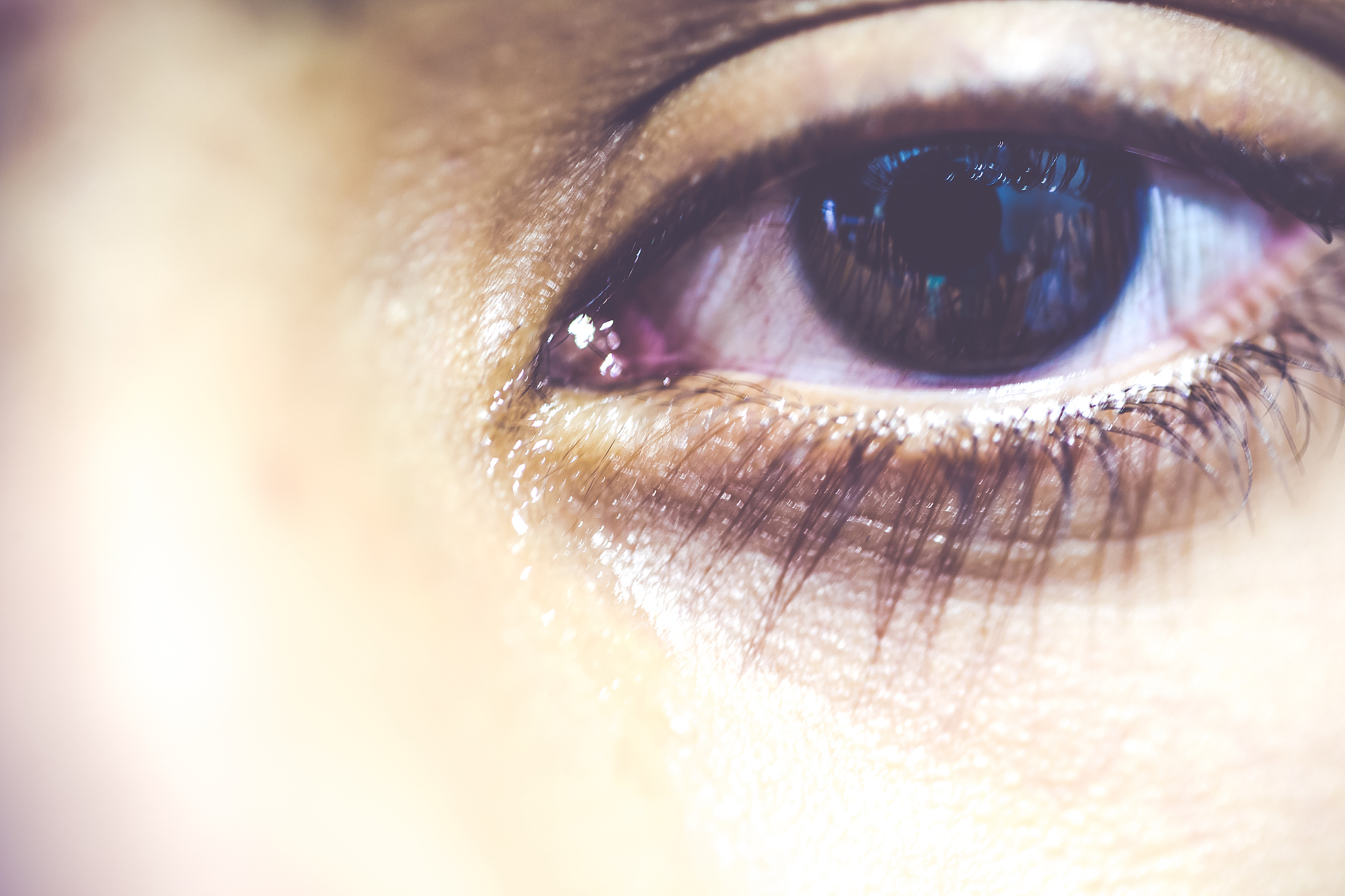 close-up of a young adult's teary eye