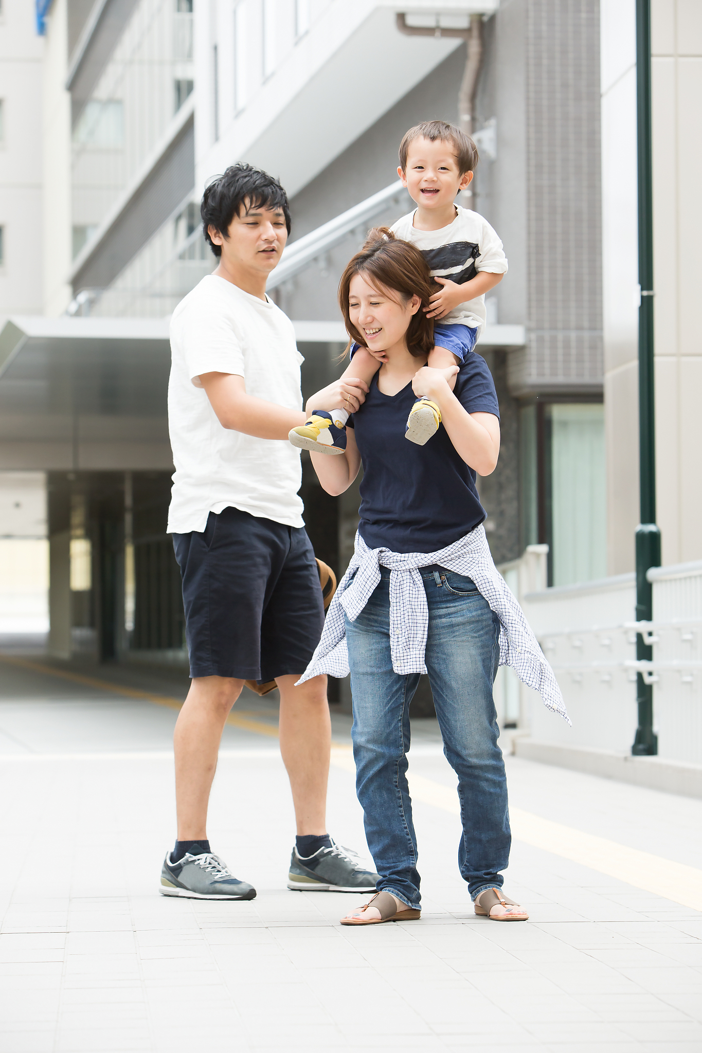 mother shouldering a son, father watching.