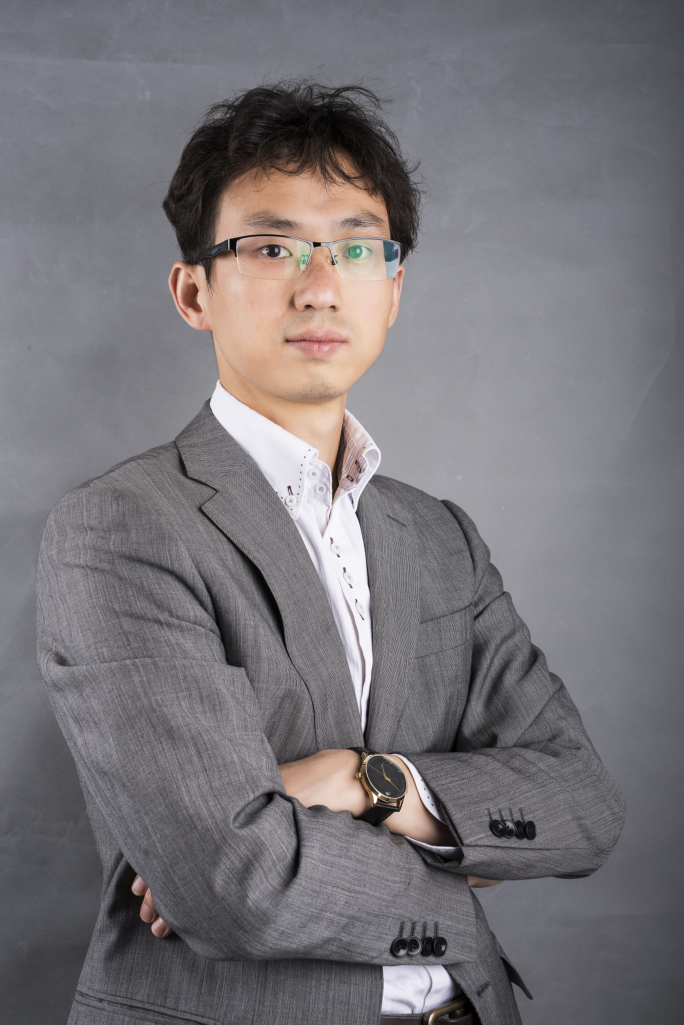 single young asian businessman in front of a gray background