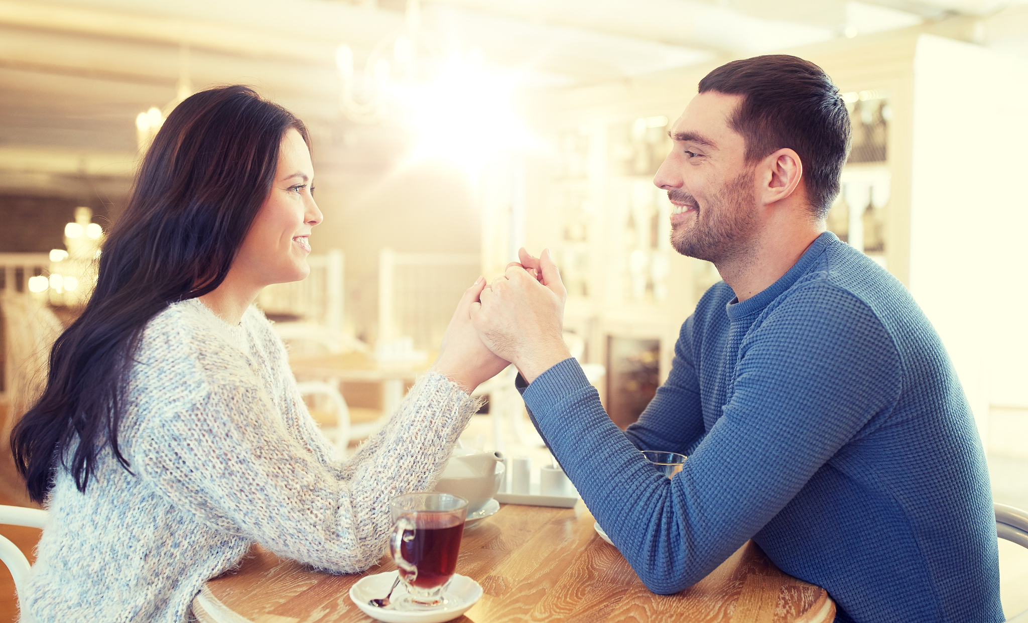 people, love, romance and dating concept - happy couple drinking