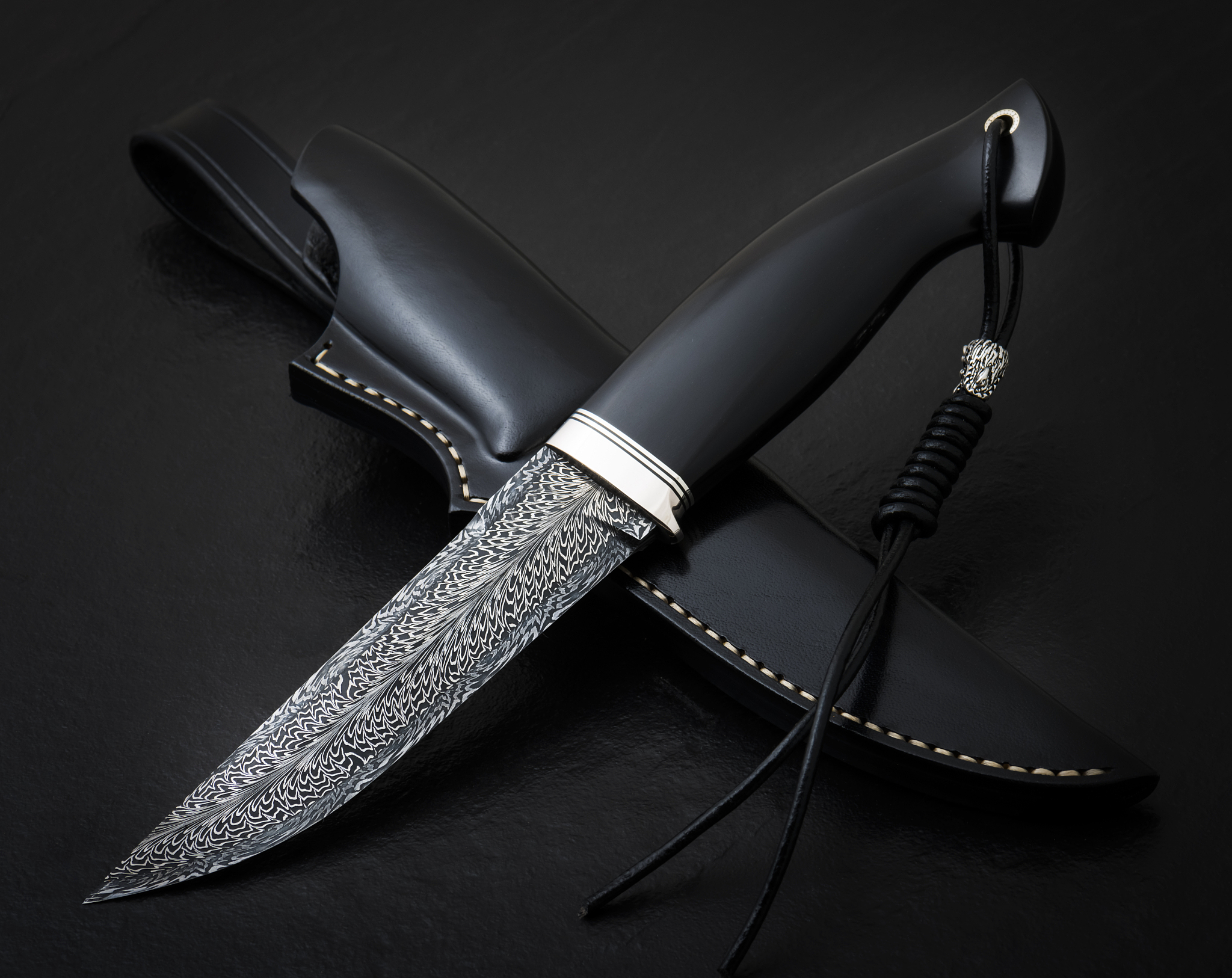 hunting knife from damascus mosaic with mammoth tusk on a black 