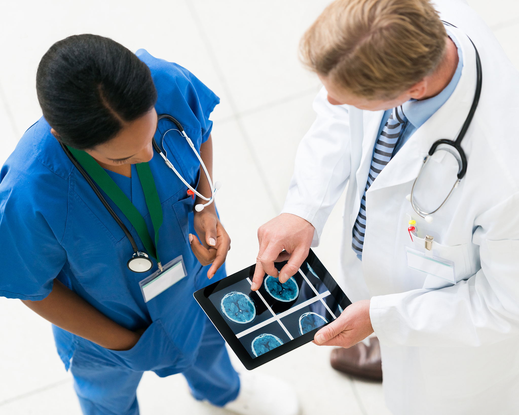 doctors with digital tablet discussing cat scans