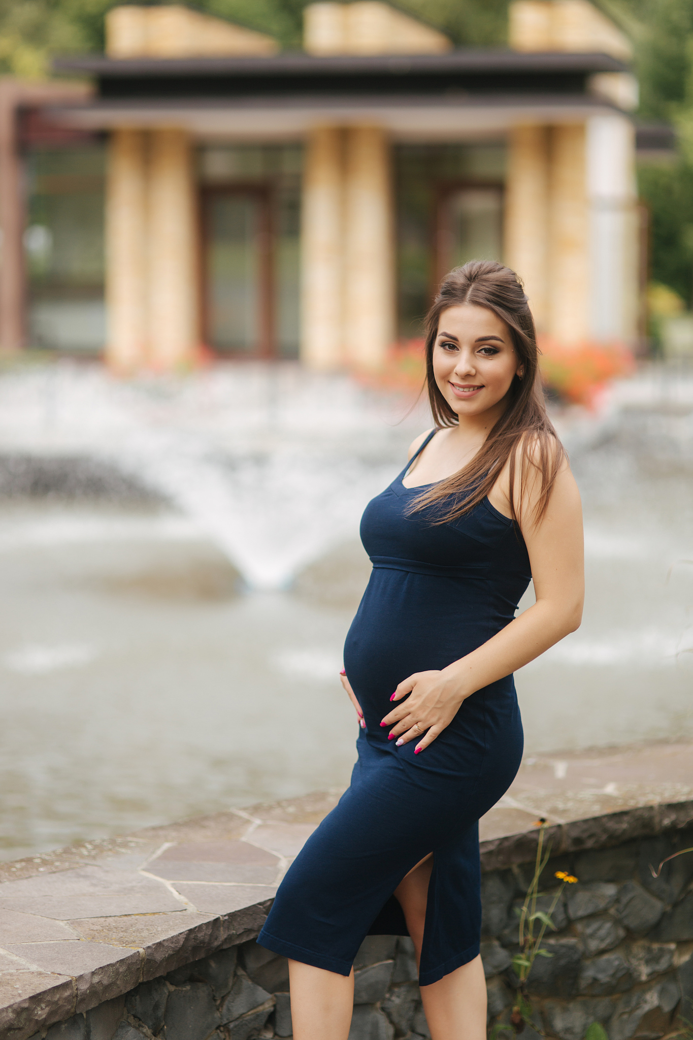beautiful young cheerful pregnant woman standing in background o
