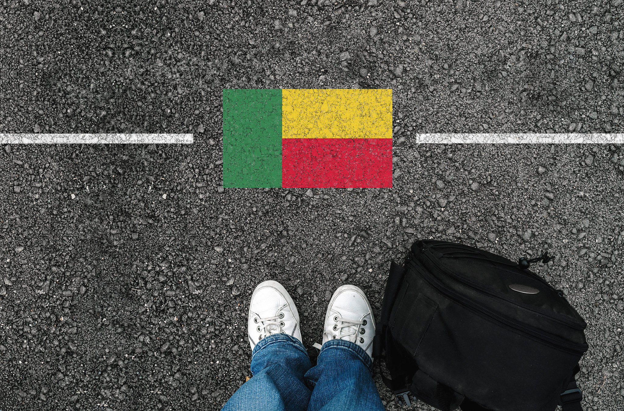 a man with a shoes and flag of benin and border