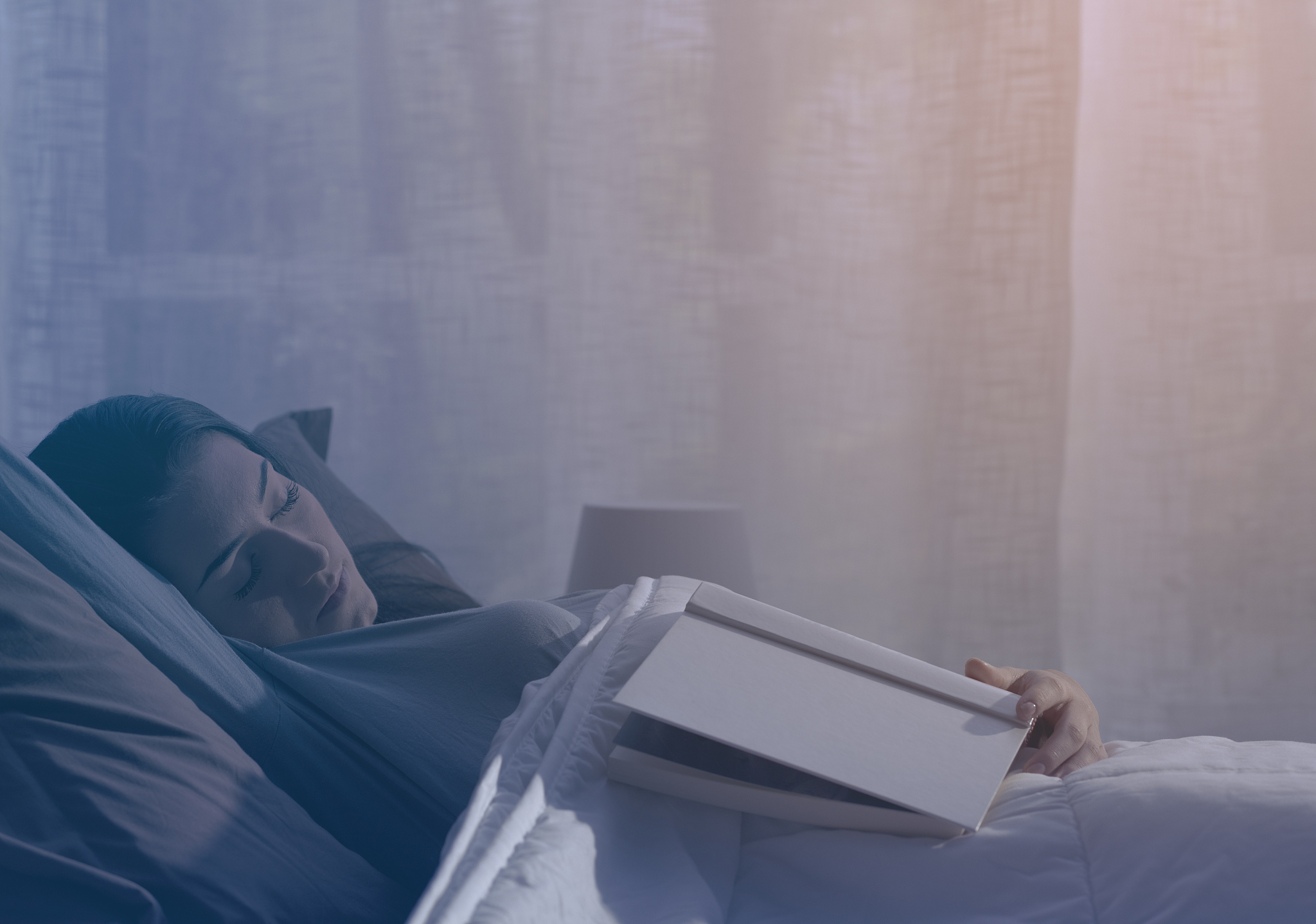 woman falling asleep while reading a book