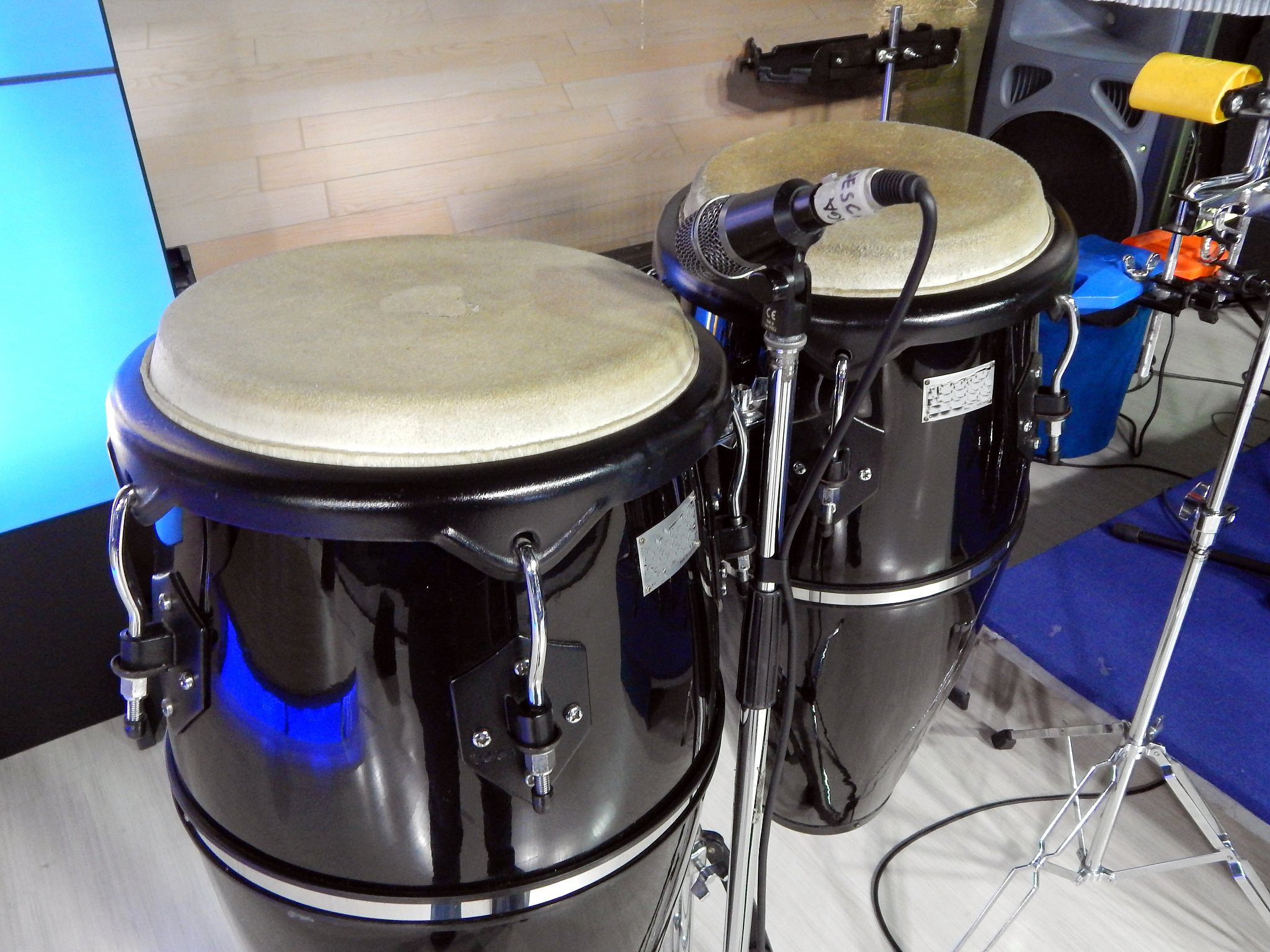 bongos with microphone in front and a speaker