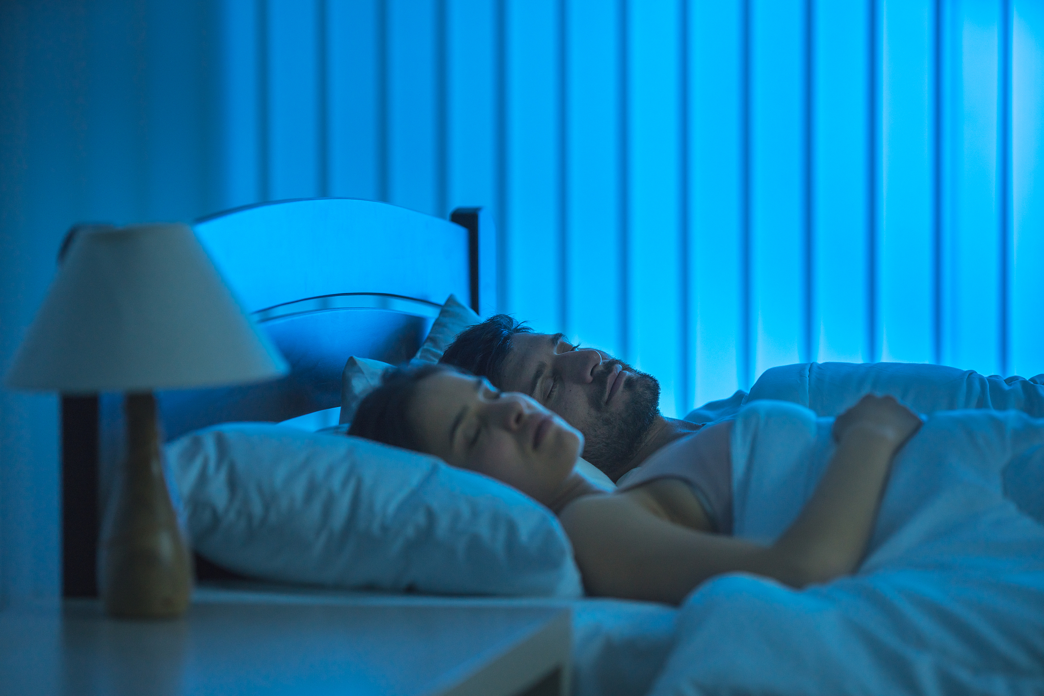 the sleeping lovers on the bed. night time