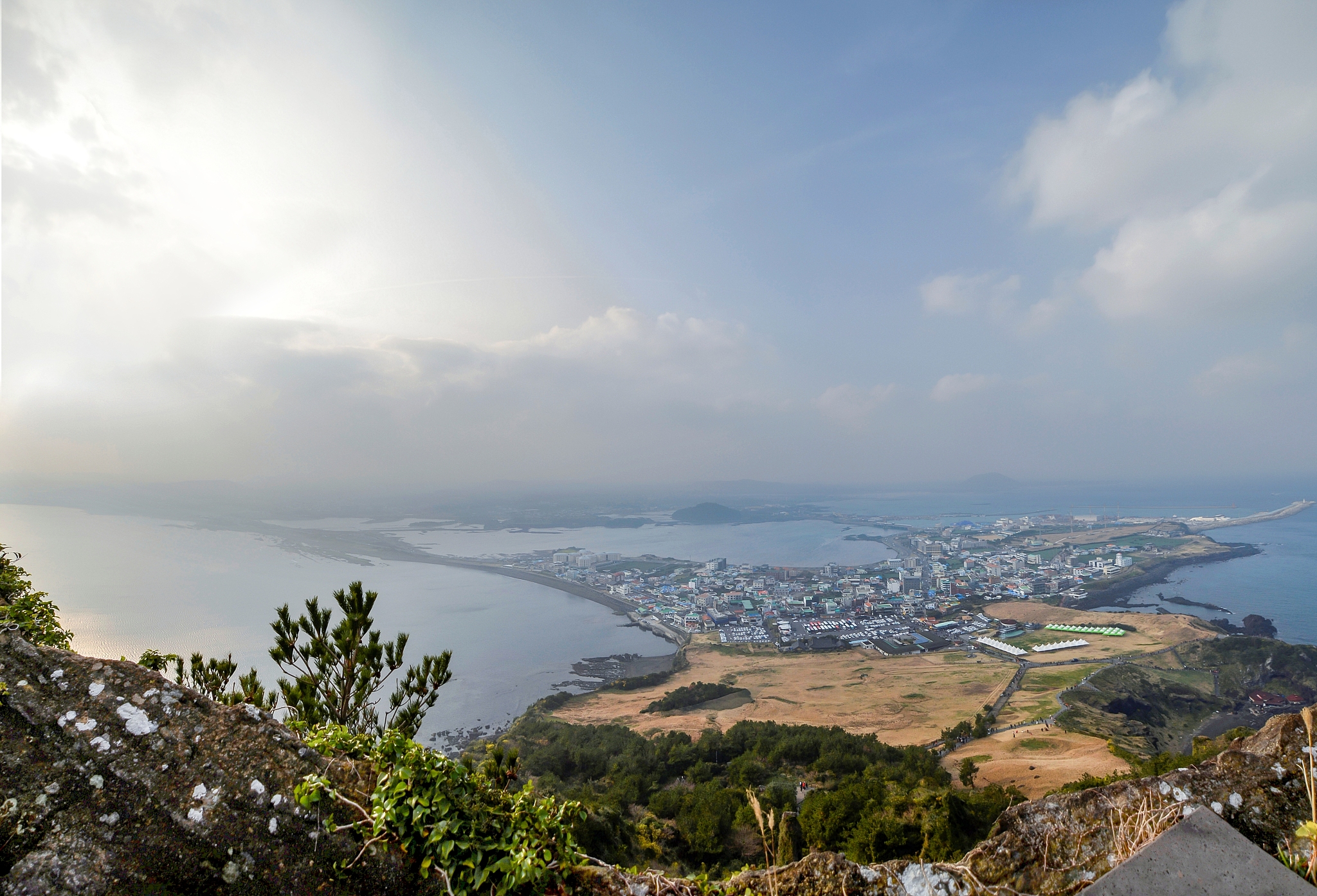 high angle view of sea and cityscape against sky