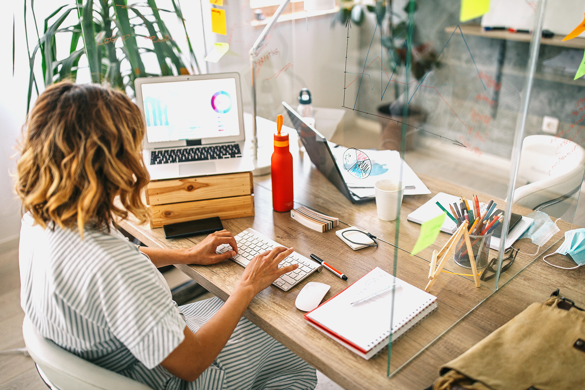 woman in striped dress working in office