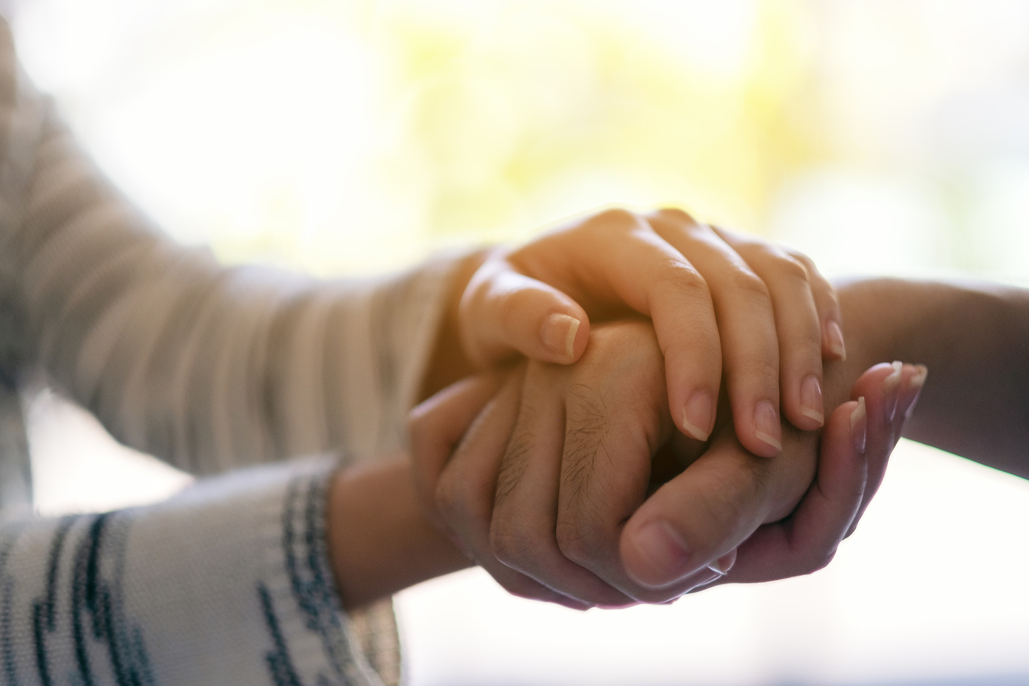 a man and a woman holding each other hands for comfort