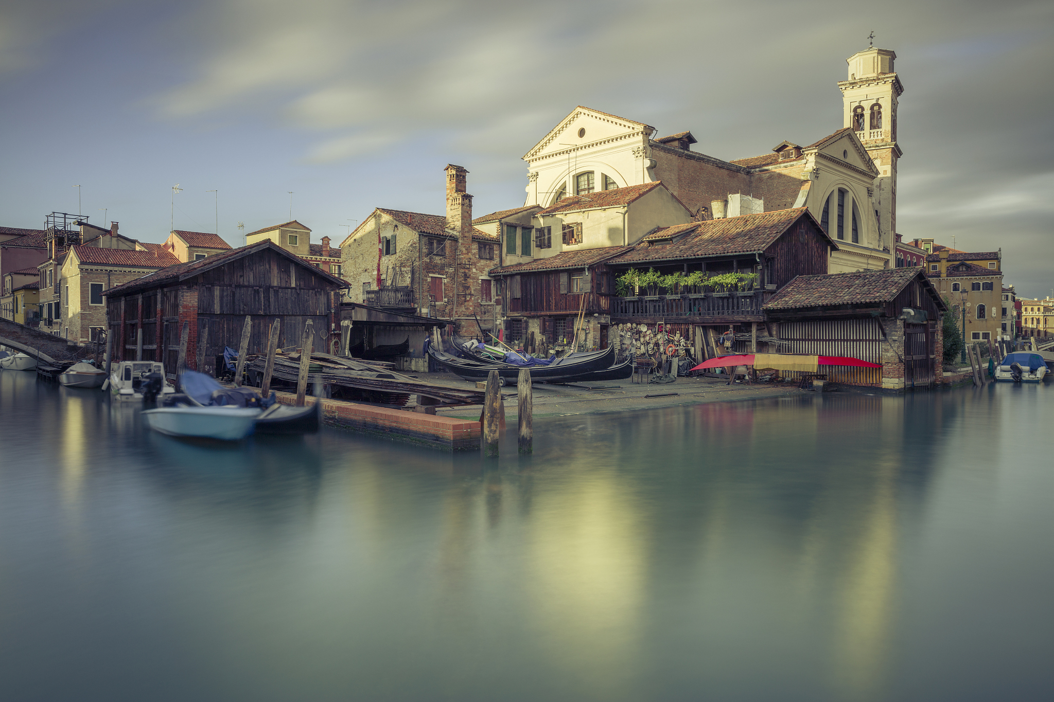 a 17th-century traditional wooden boatyard with gondolas in sque