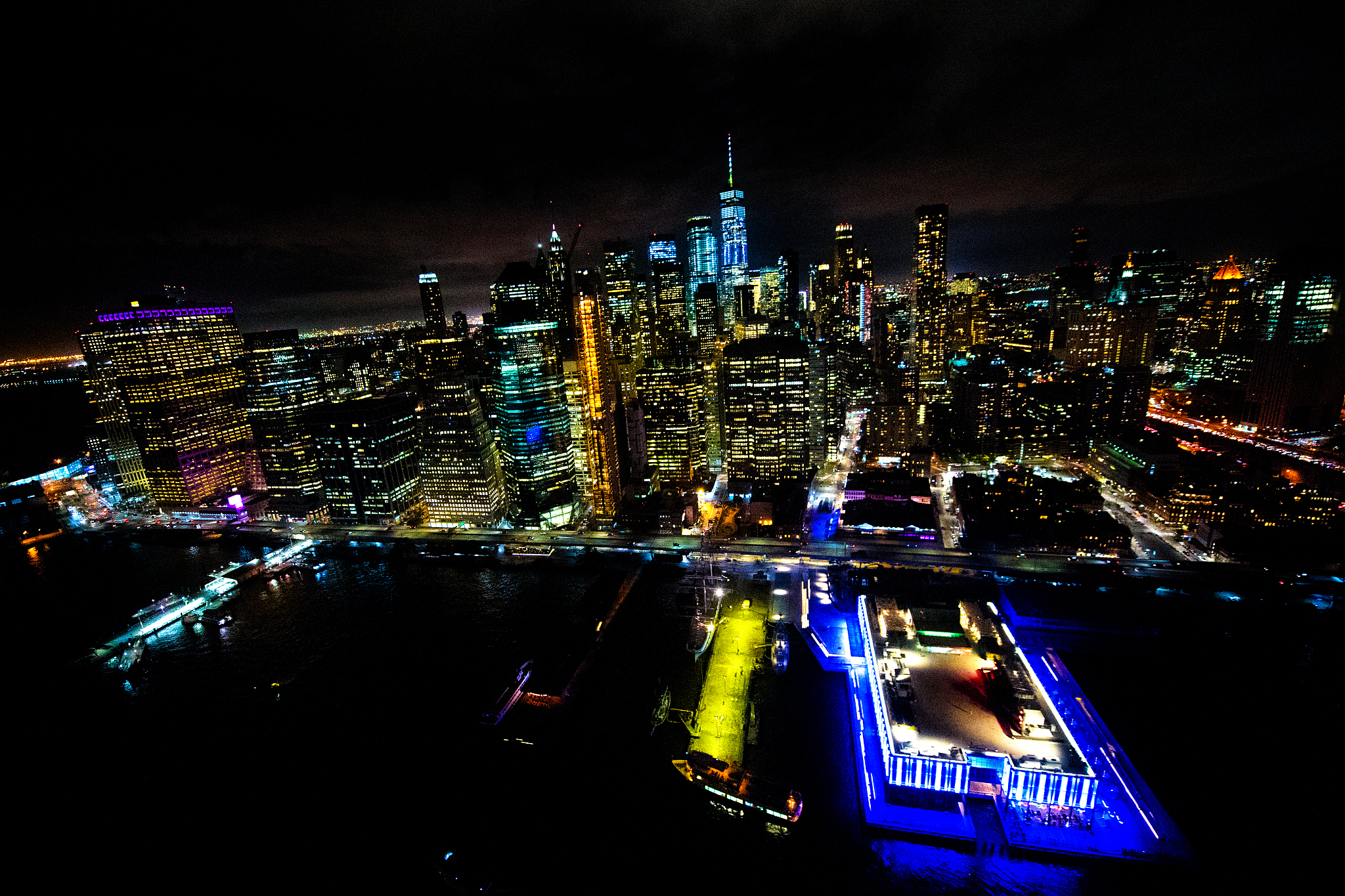 lower manhattan piers and docks at nighttime shot from a helicop