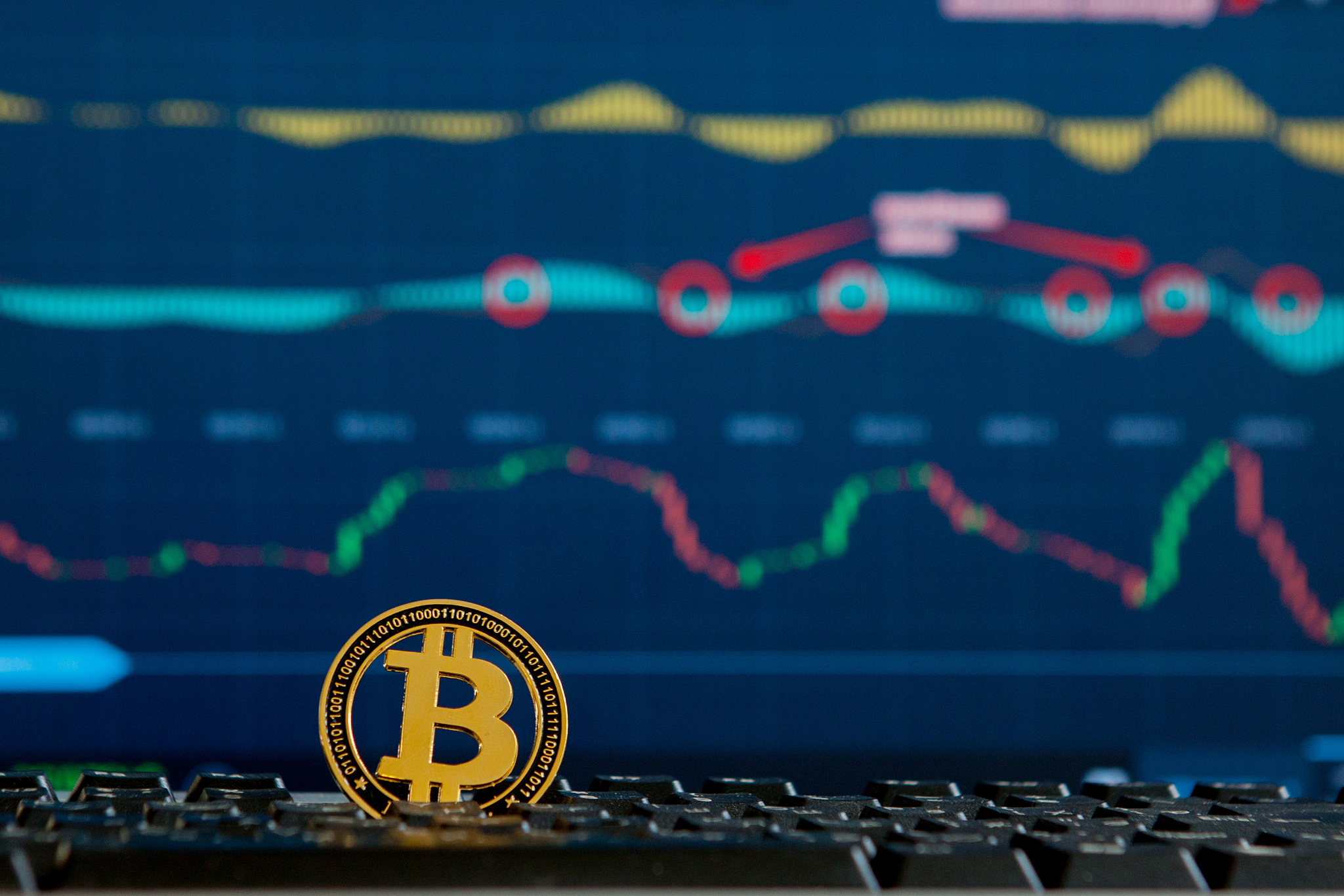 bitcoin gold coin and defocused chart background. virtual crypto
