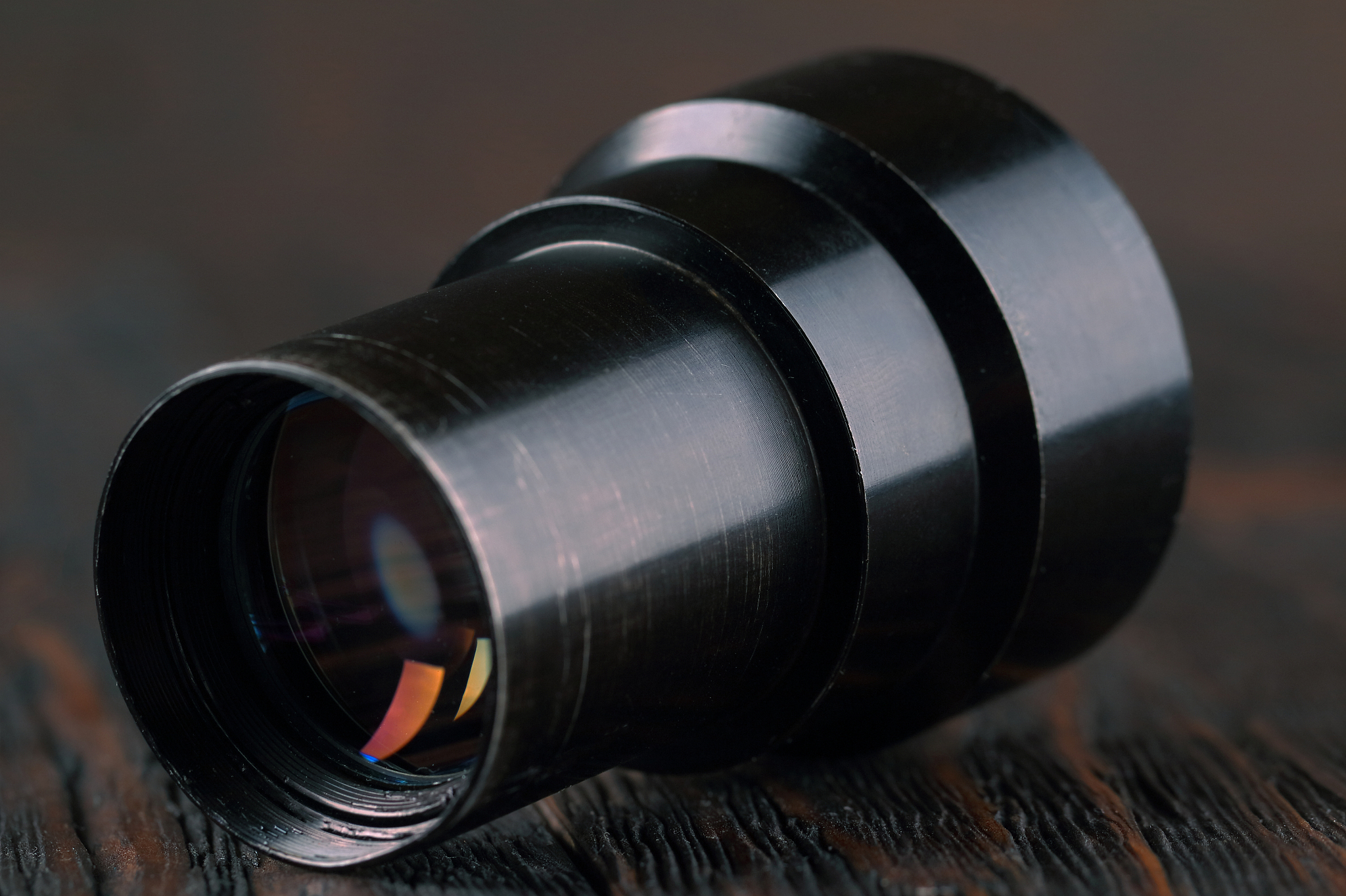 old lens from old camera on the wooden table