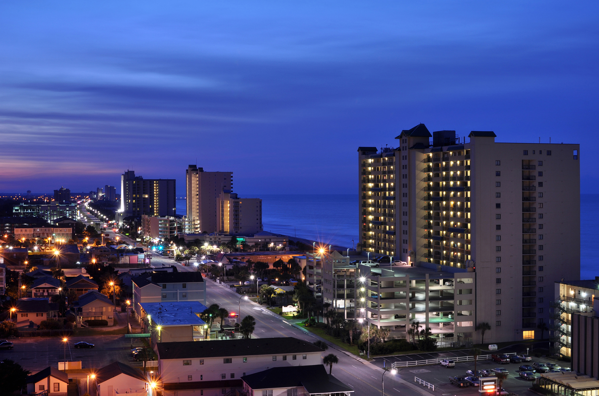 vacation rentals and businesses on coast at night