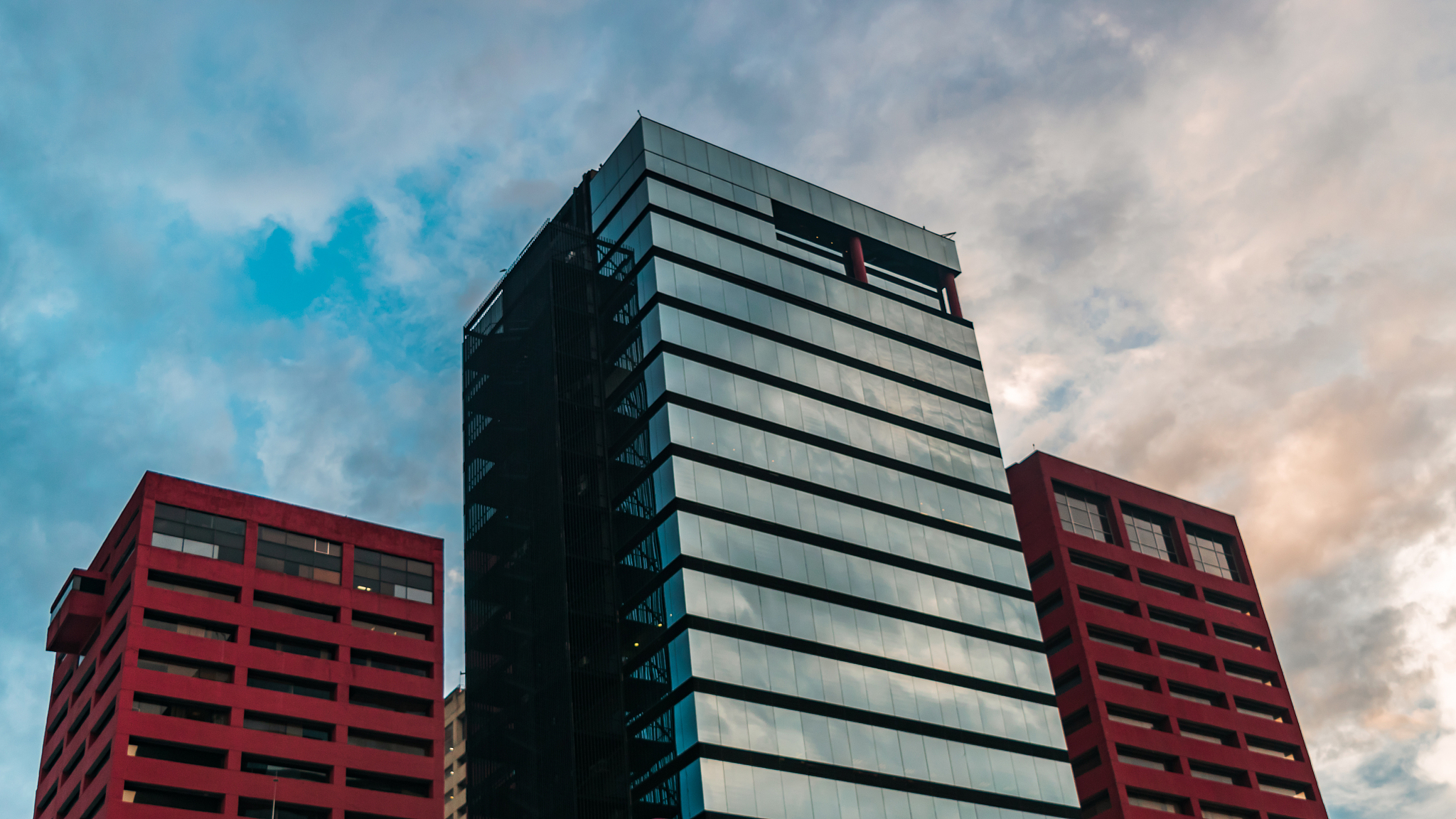 banner of three corporate buildings at sunset