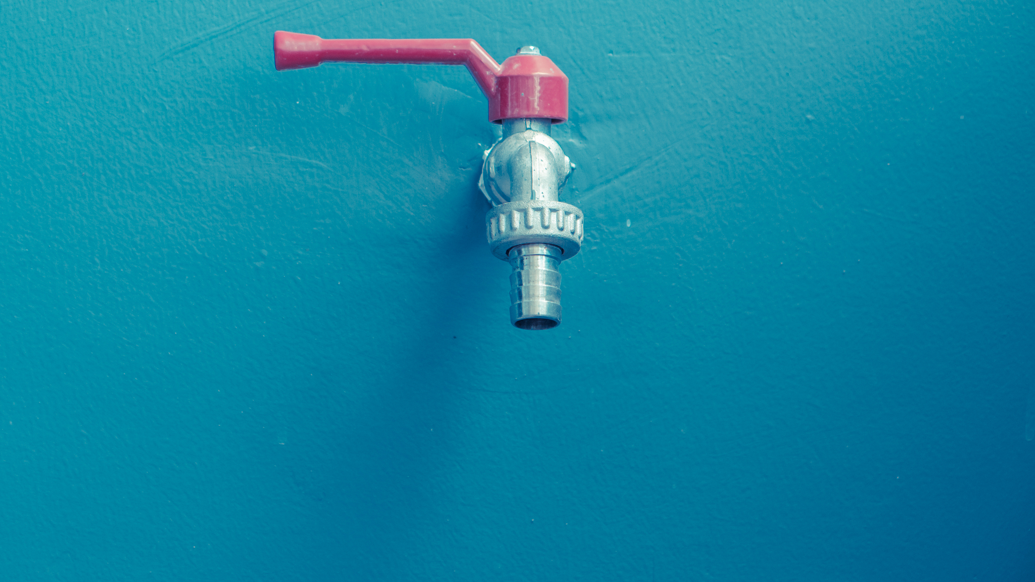faucet on blue wall