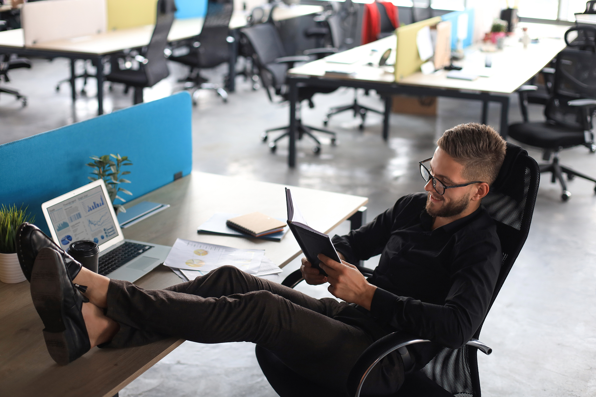 focused modern businessman working and taking notes in his moder