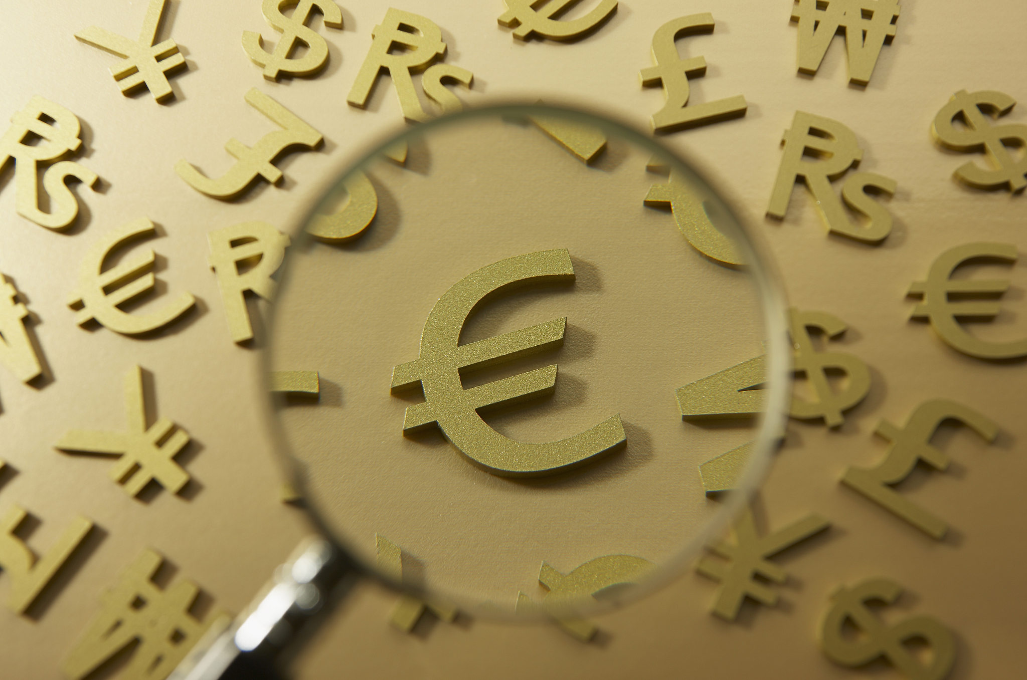 magnifying glass on euro symbol.