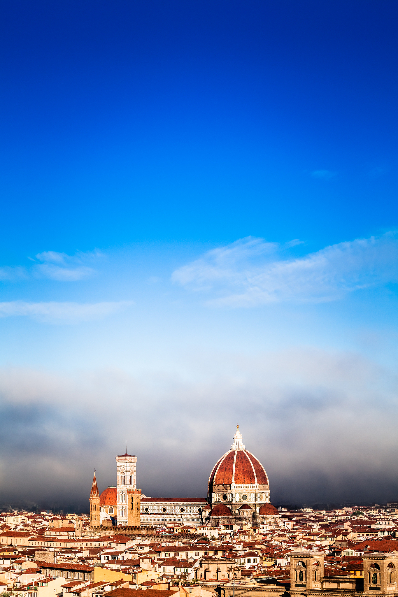 duomo di firenze surrounded by a wall of fog