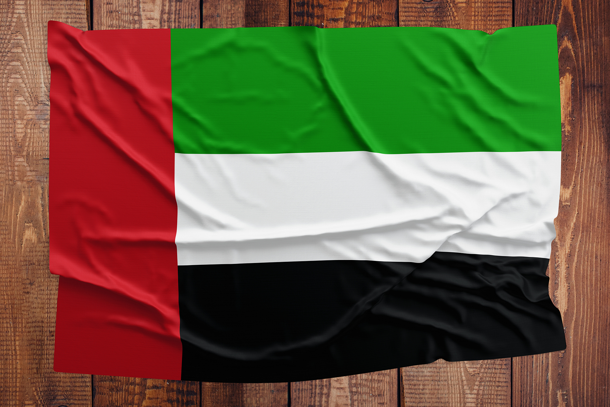 flag of united arab emirates on a wooden table background. wrink