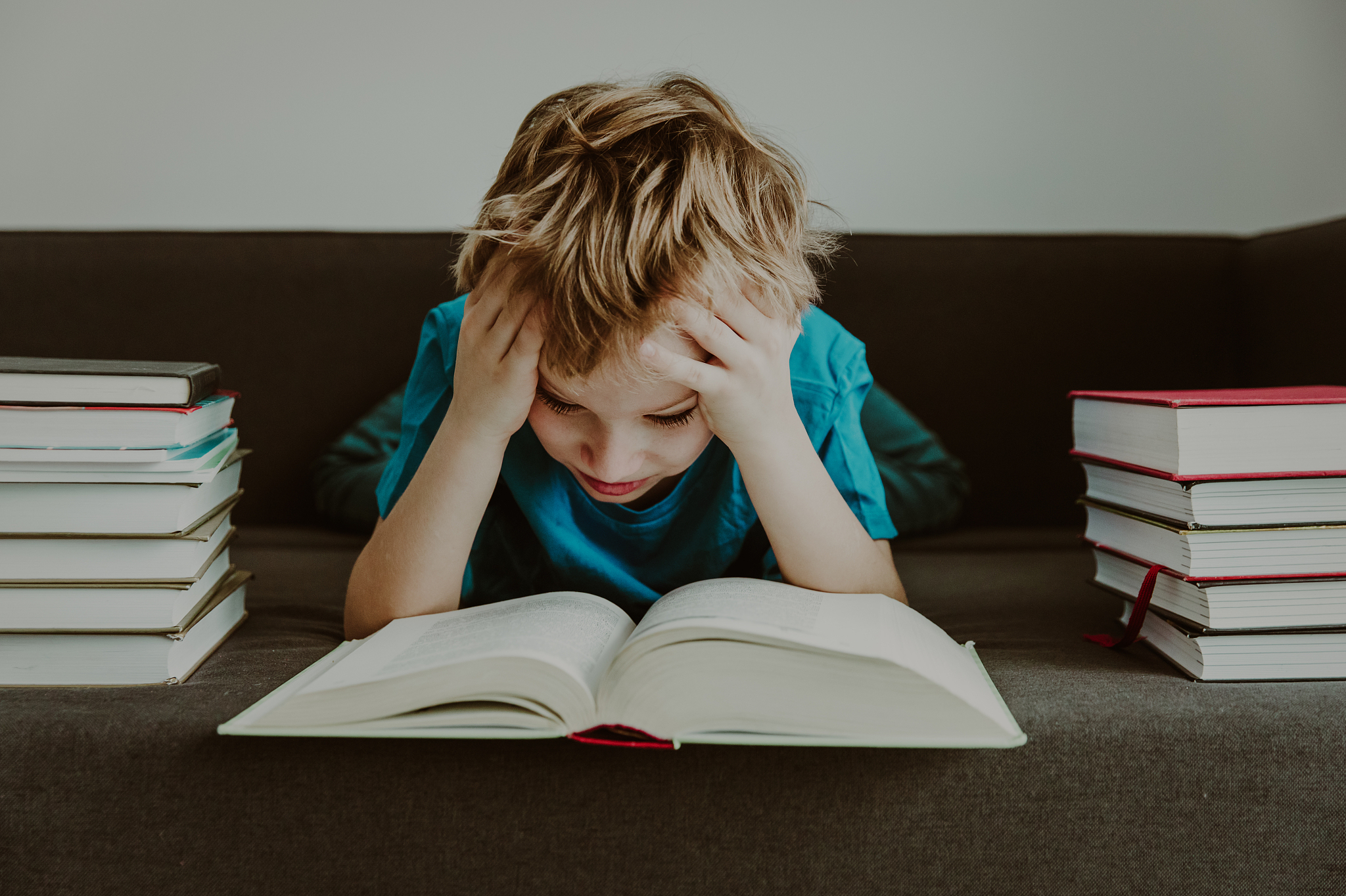 little boy tired stressed of reading, doing homework